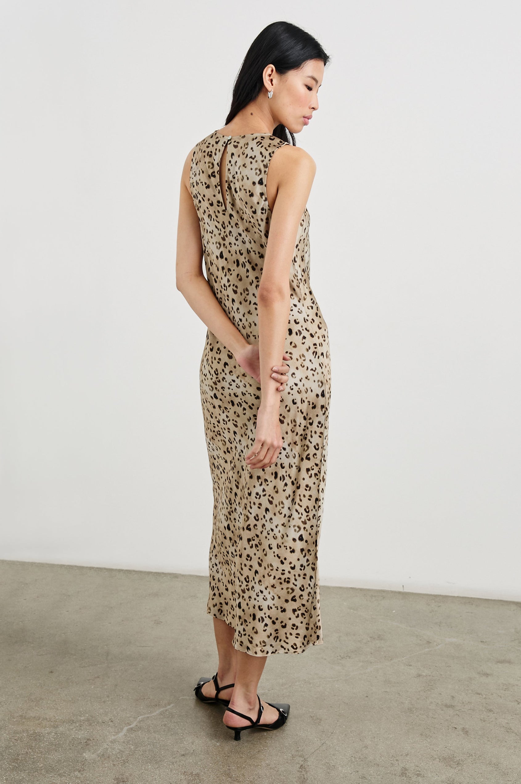 Gabriella Sleeveless Midi Dress with a Crew Neck, a Left Thigh Side Slit, a Ruched Drawstring on the Left Side and a Keyhole Button Closure at the Back in Champagne Leopard Colorway, with Black and Brown Spots on Champagne - Back Full Body View Featured on Model
