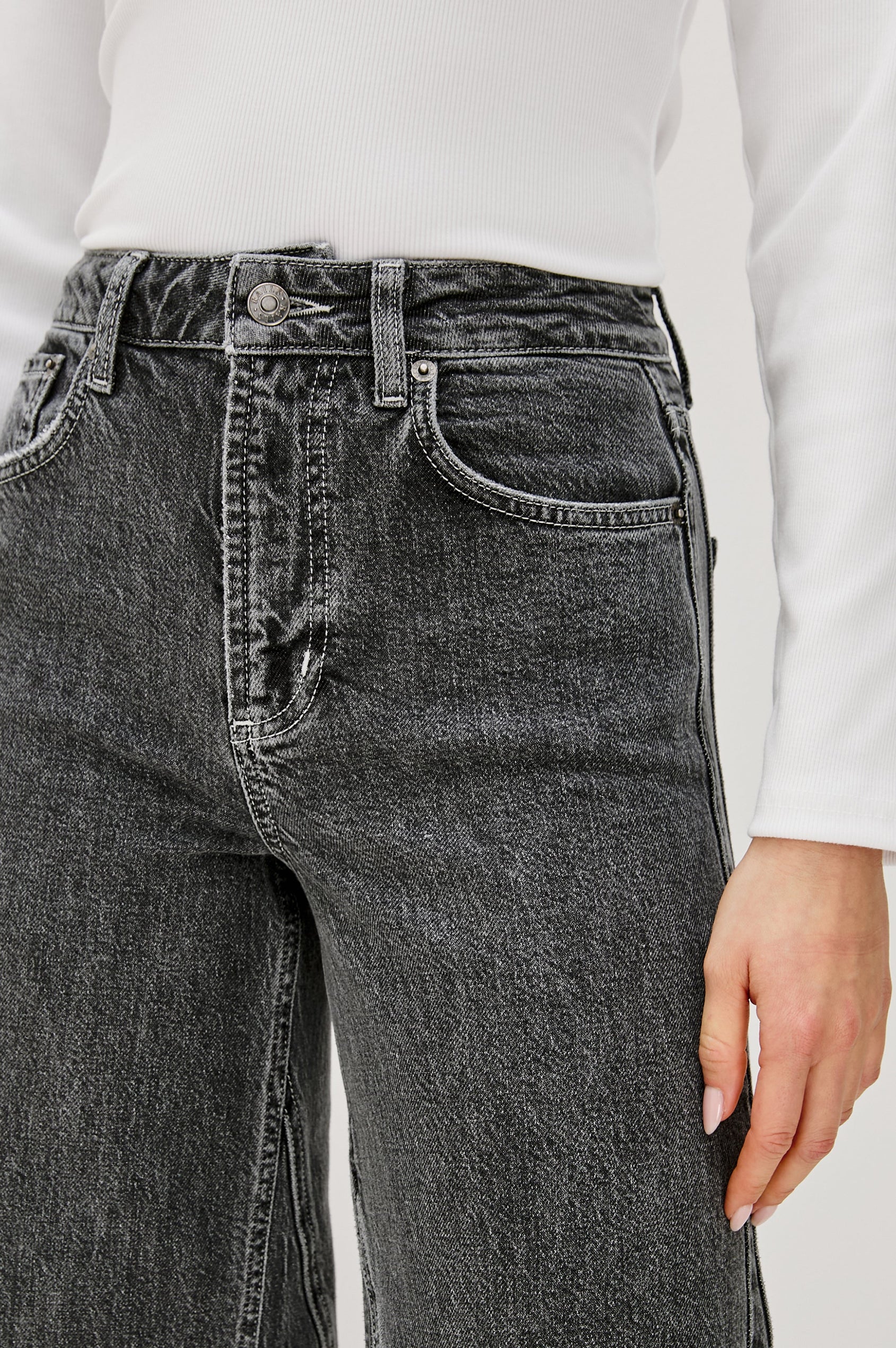 Getty Twist Seam Wide Leg Denim Pants with a Diagonal Seam Across the Leg, Belt Loops, Two Front Pockets and Two Back Patch Pockets in Washed Charcoal Colorway - Front Detail View Featured on Model