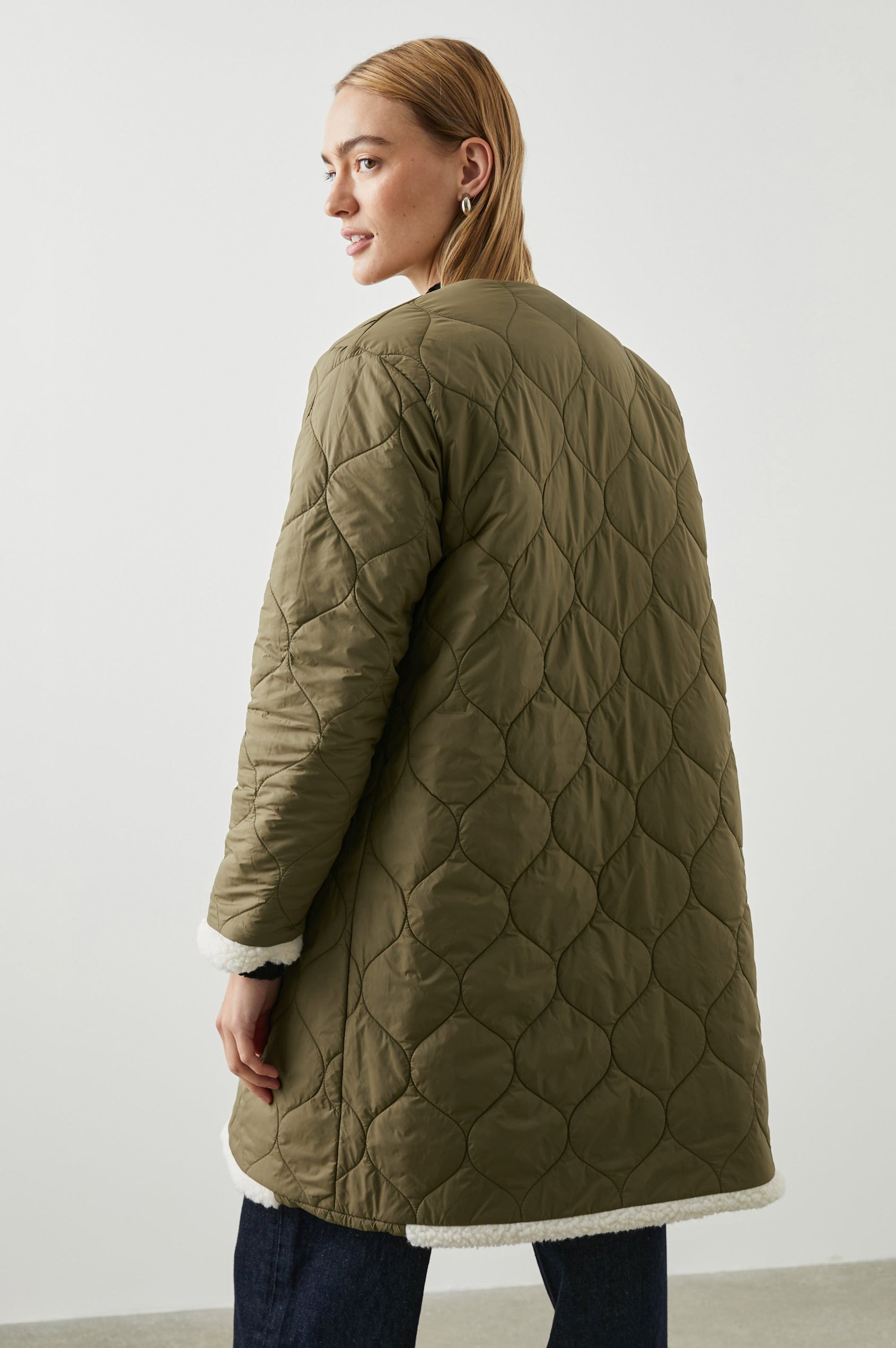 Granger Knee-Length Reversible Jacket with Zip Closure, One Side Quilted with Two Front Patch Pockets, the Reverse Side Ivory Sherpa Fleece with Olive Quilted Horizontal Bands in Ivory Olive Mix Colorway - Back Quilted View Featured on Model