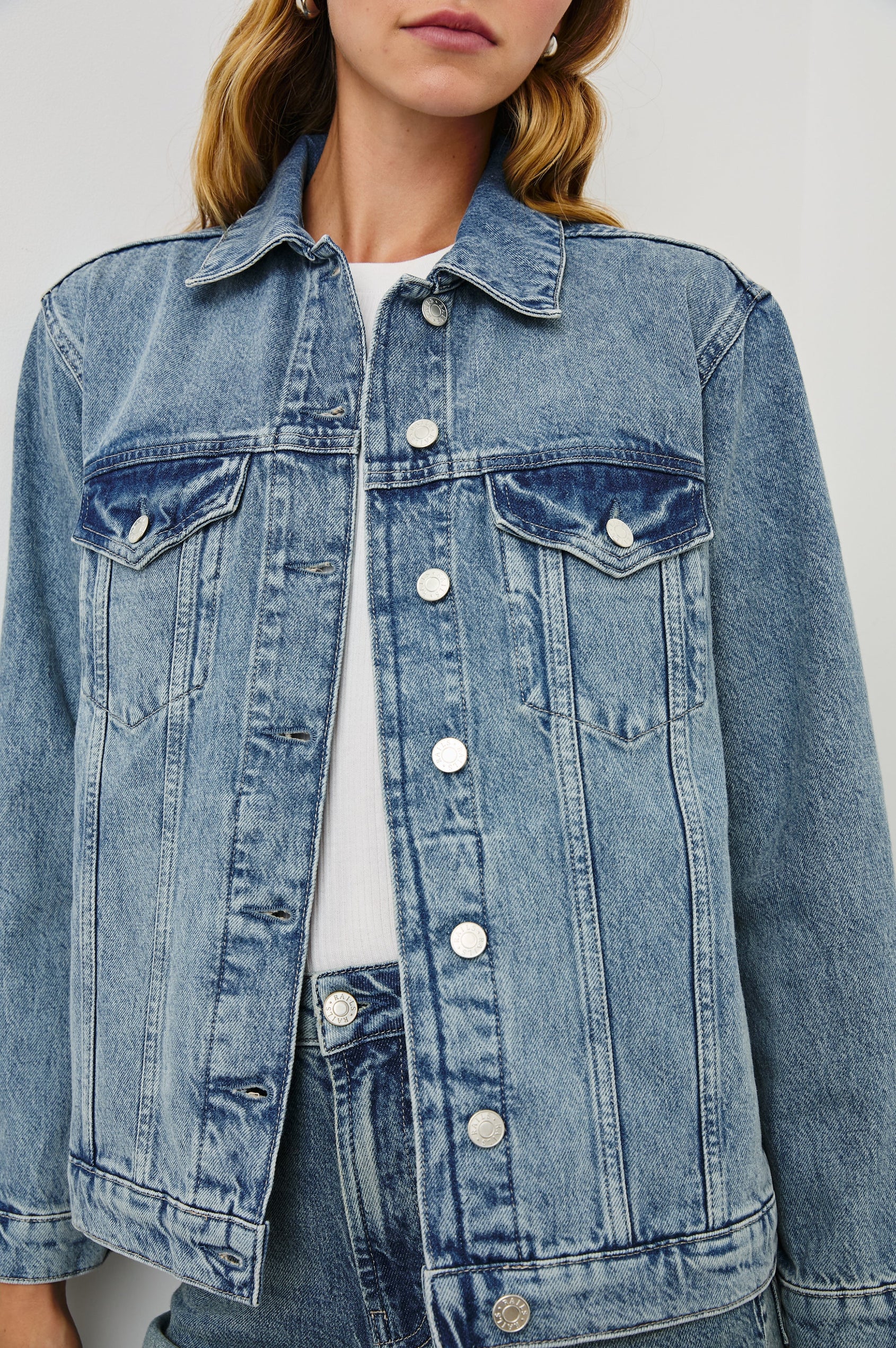 Grove Boyfriend Trucker Denim Jacket with Button Closure, Two Front Pockets, Two Chest Button Flap Pockets, Front Vertical Seams in Embossed Indigo Colorway - Front View Featured on Model