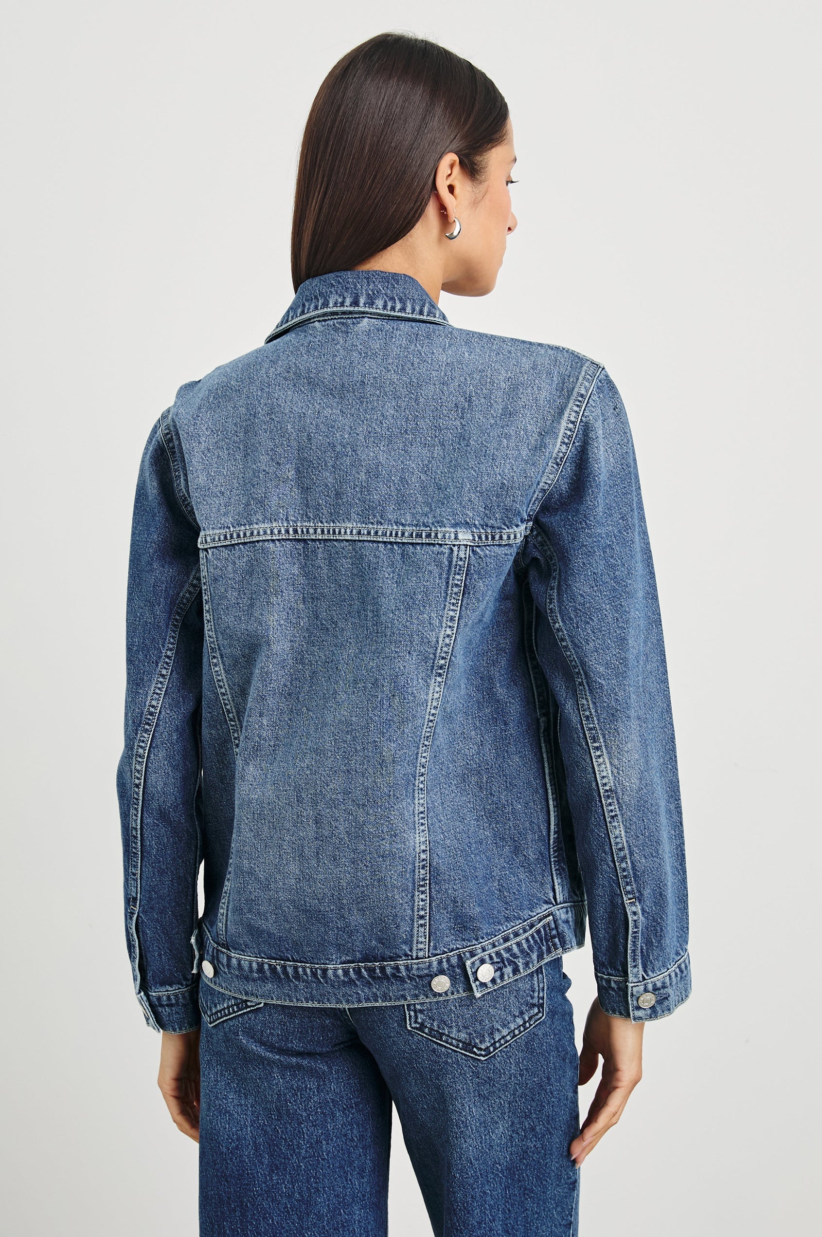 Grove Boyfriend Trucker Denim Jacket with Button Closure, Two Front Pockets, Two Chest Button Flap Pockets, Front Vertical Seams in Indigo Haze Colorway - Back View Featured on Model