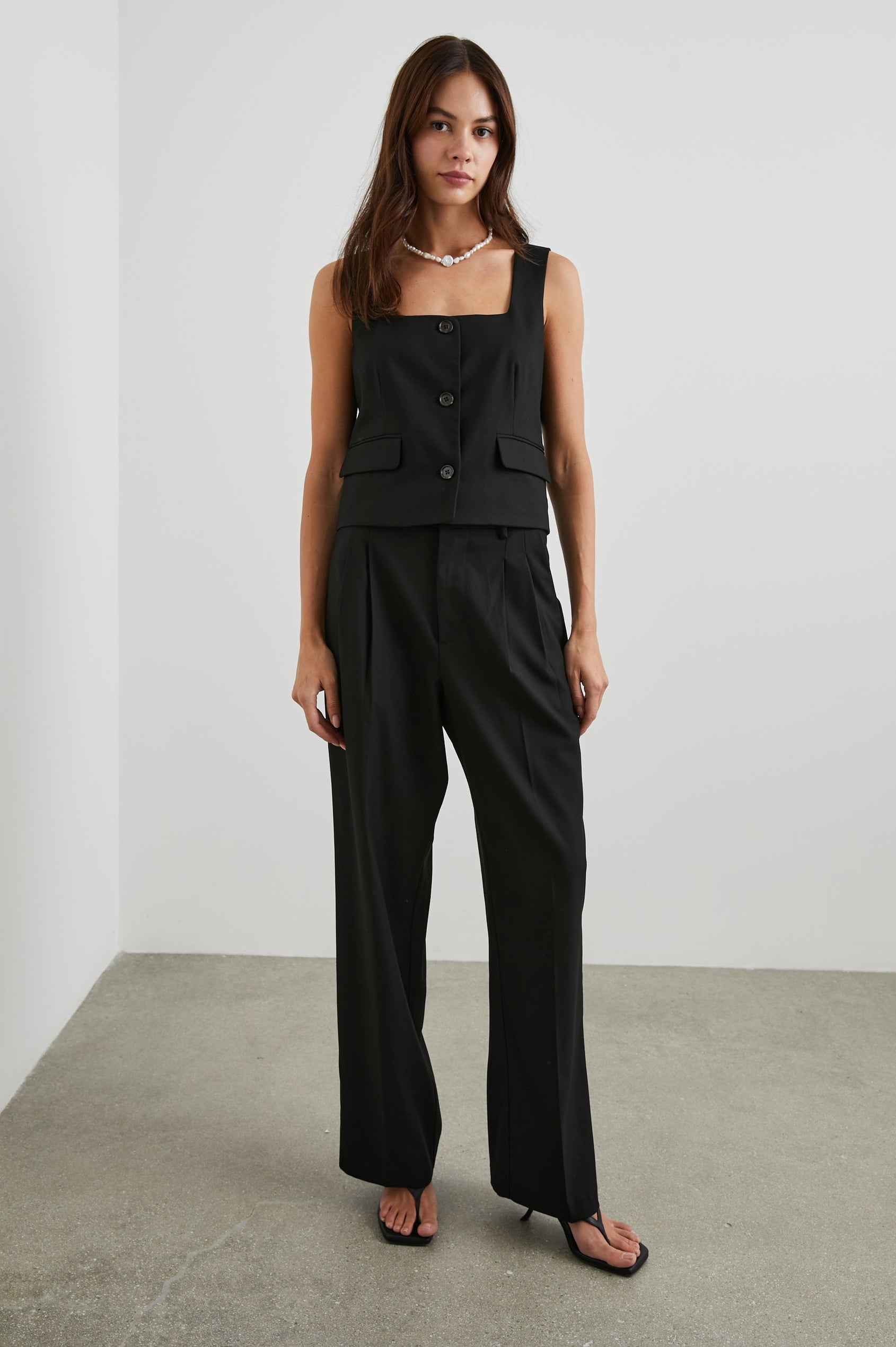 Guilia Cropped Vest with a Square Neckline, Button Closure and Two Front Flap Pockets in Black Twill Colorway - Front Full Body View Featured on Model