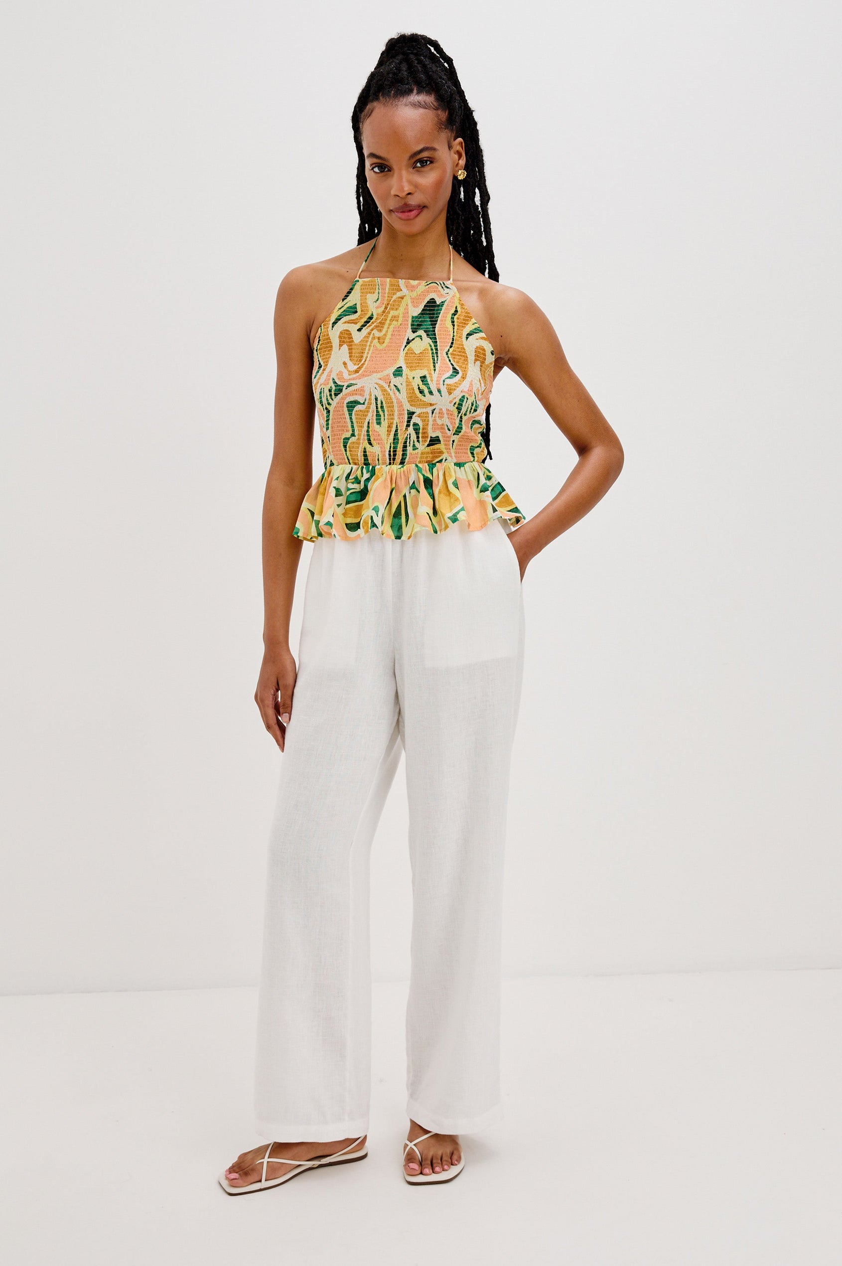 Gwendolyn Square Neck Halter Top with Smocked Body and a Ruffled Peplum Hem in Tulum Colorway. Full Body Front View Shown on Model.