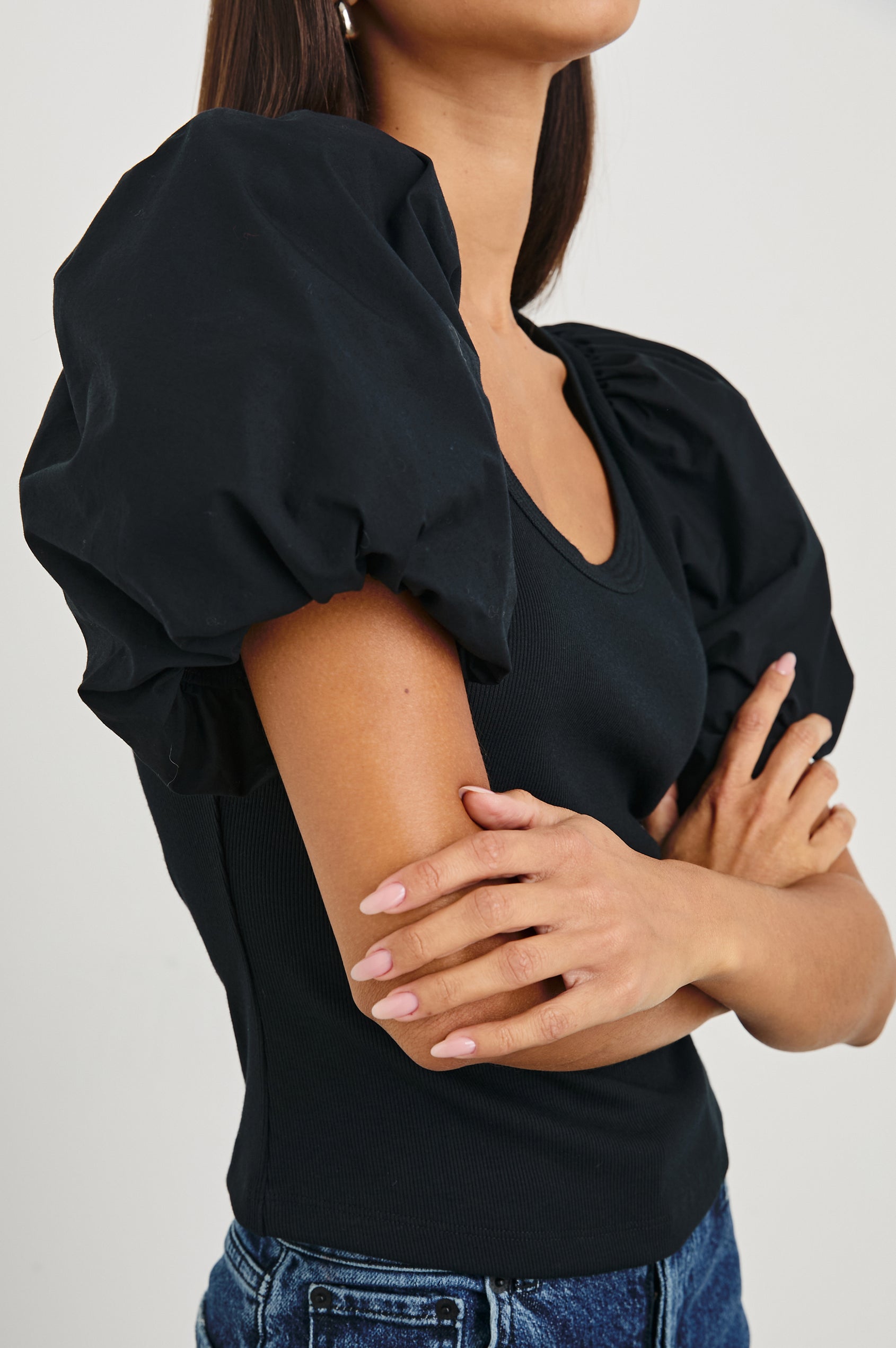 Hallie Short Sleeve Top with a Scoop Neck and Puff Sleeves in Black Colorway - Side View Featured on Model