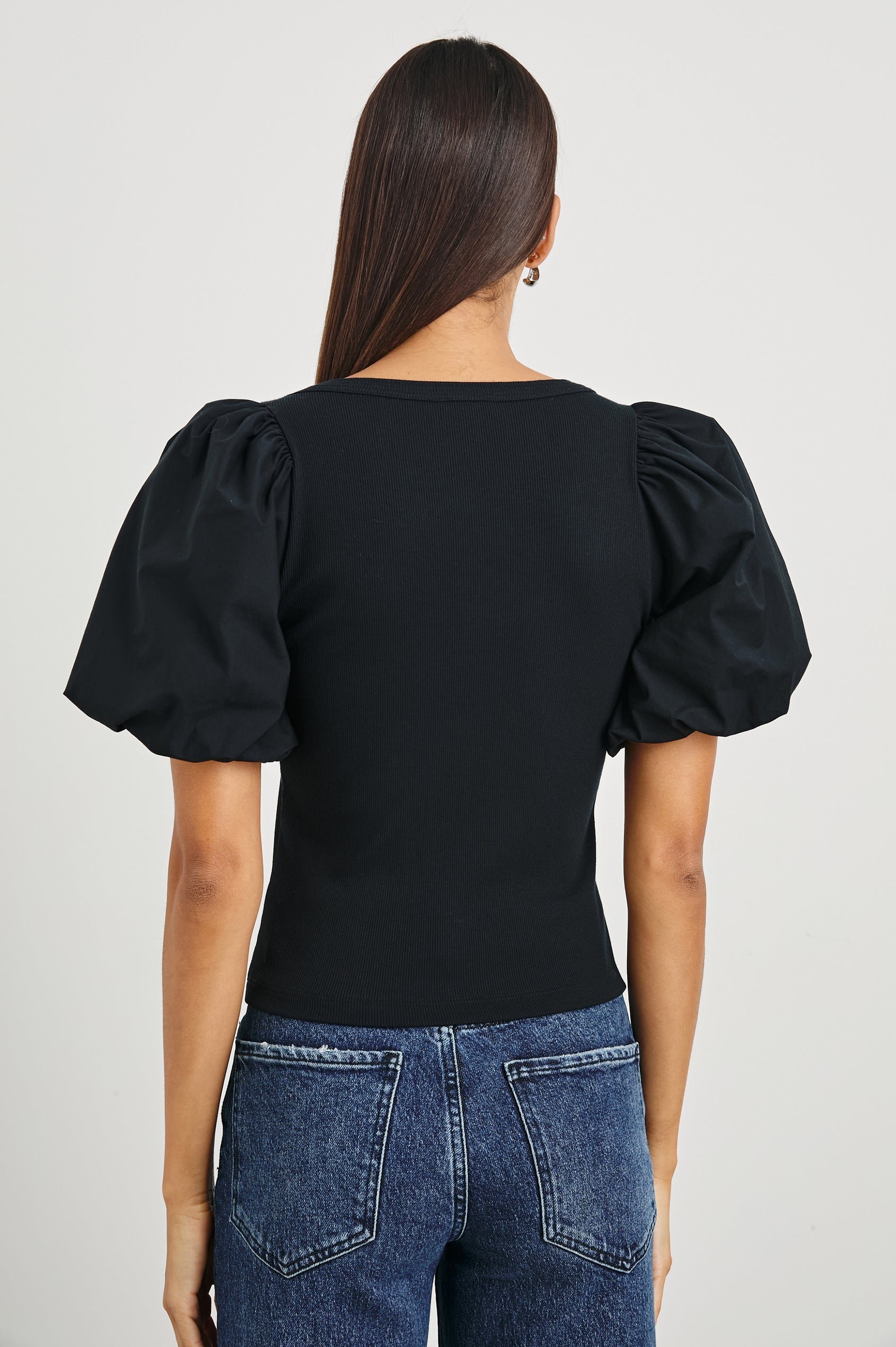 Hallie Short Sleeve Top with a Scoop Neck and Puff Sleeves in Black Colorway - Back View Featured on Model