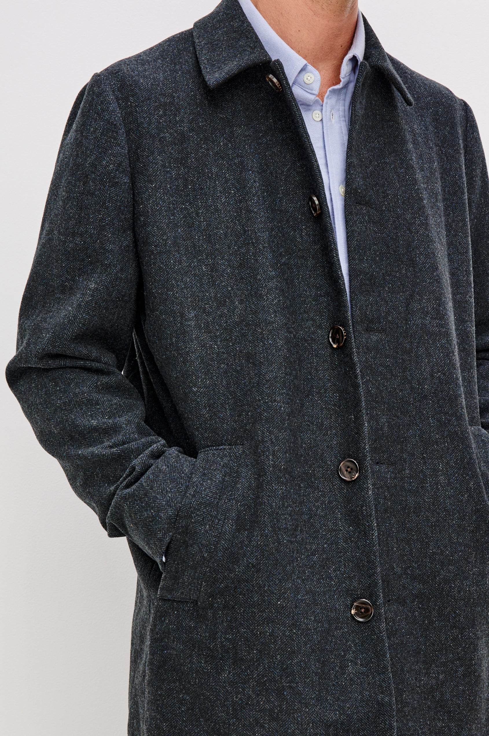 Hockney is a traditional top coat, wool-blended and lined with welt pockets, interior pockets on both sides (invisible zipper and welt), and a back vent, in Celestial Tweed Color. Front detailed view featured on model.