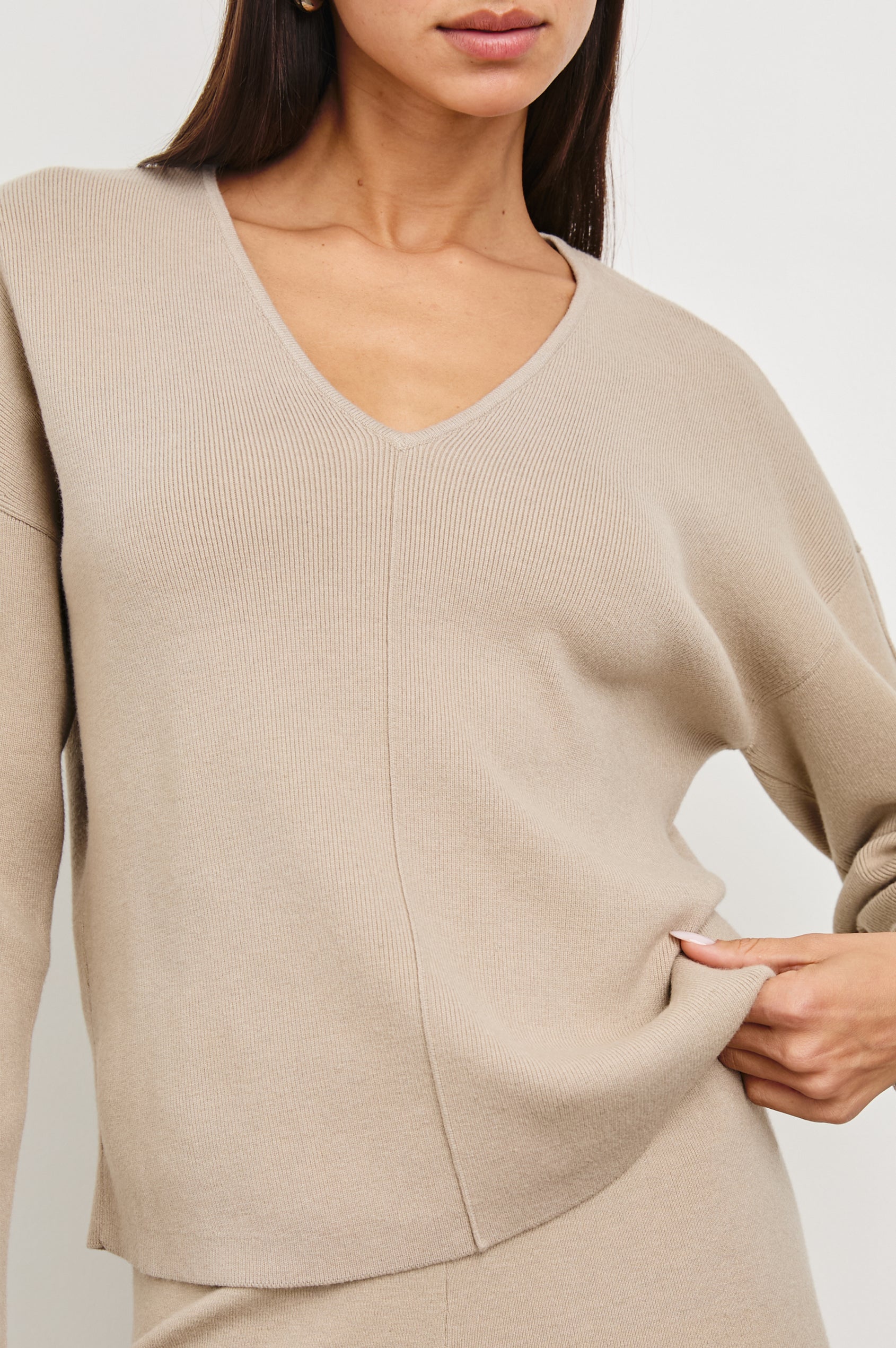 Hollyn Long-Sleeve, V Neck Sweater with a Vertical Seam Down the Front Bodice in Oatmeal Colorway - Front View Featured on Model