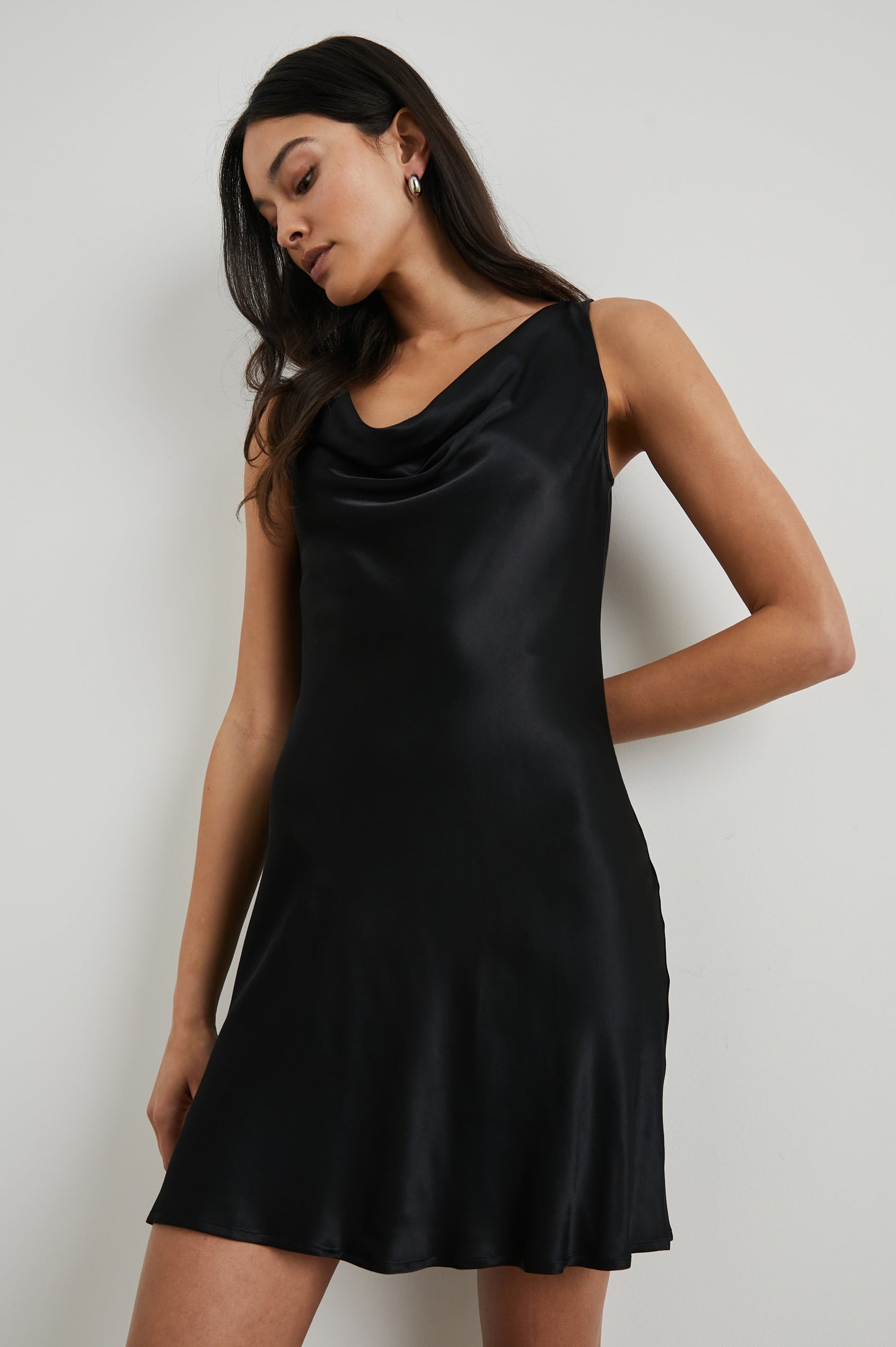 Indra Sleeveless Mini Dress with Wide Straps and a Cowl Neck in Black Colorway - Front View Featured on Model