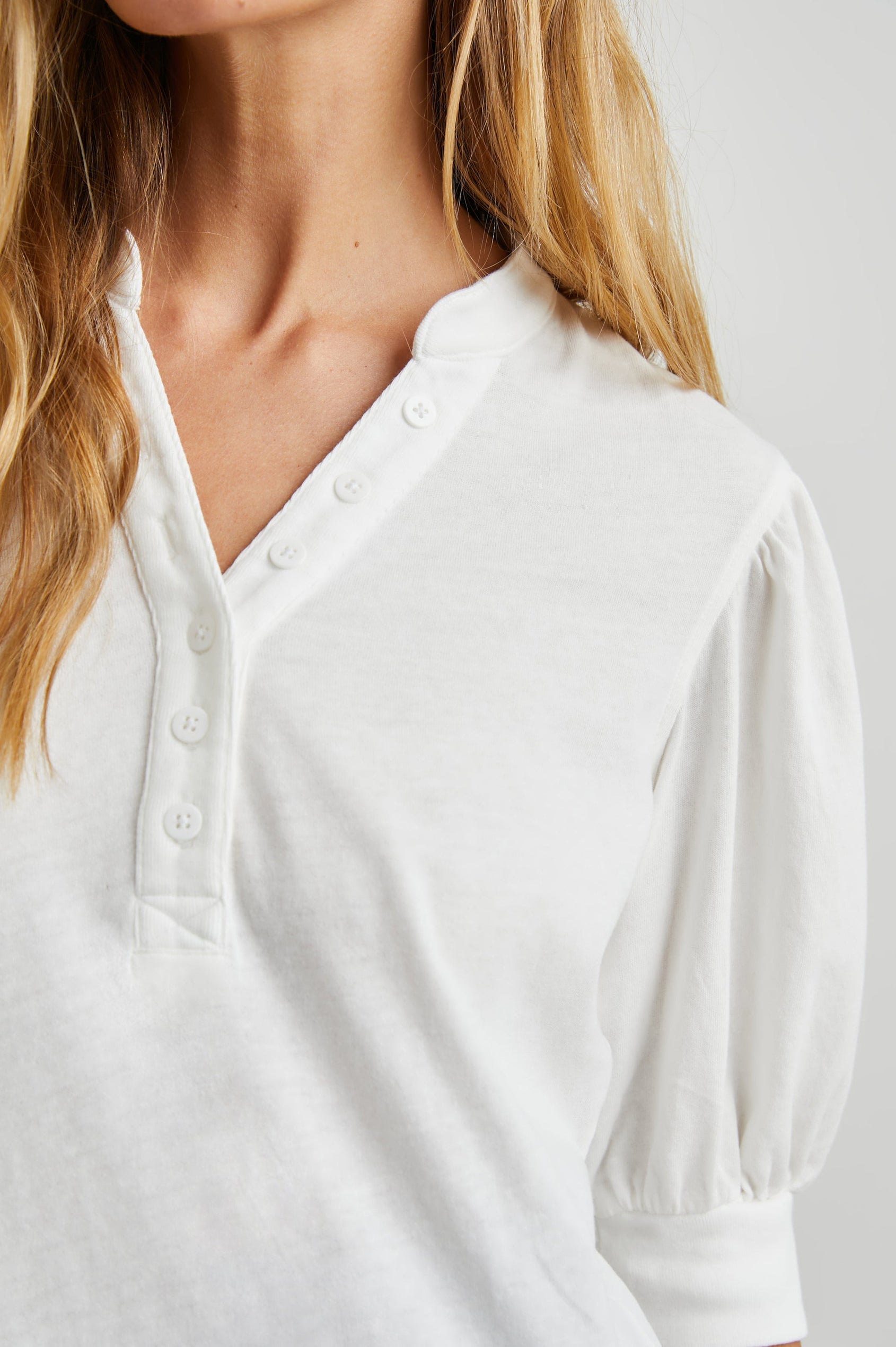 Jewel Top with Elbow-Length Sleeves, a Six Button Placket Creating a V Neck, Elasticized Cuffs and Light Ruching on Sleeves in Black Colorway - Front View Featured on Model