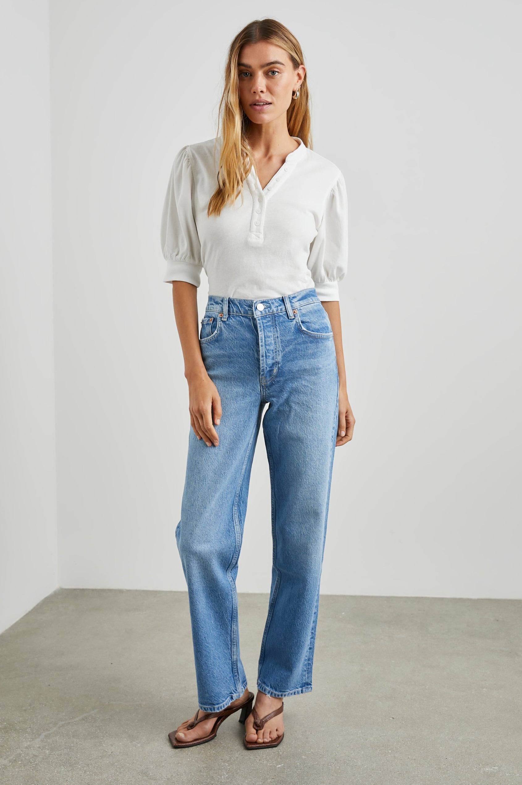 Jewel Top with Elbow-Length Sleeves, a Six Button Placket Creating a V Neck, Elasticized Cuffs and Light Ruching on Sleeves in Black Colorway - Front Tucked Full Body View Featured on Model