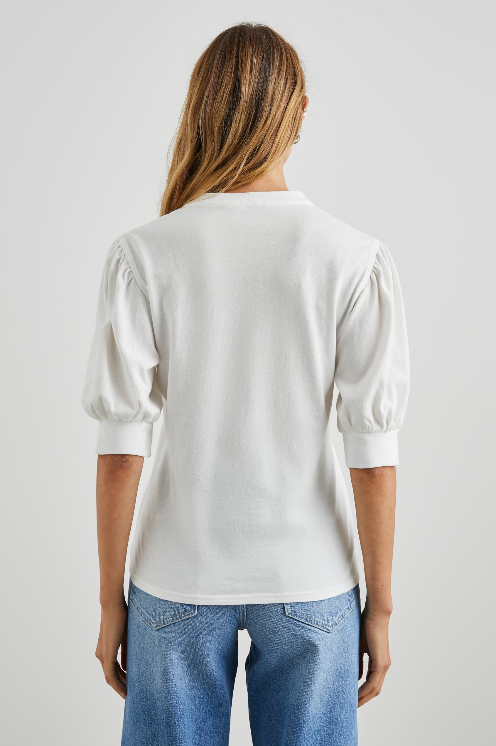 Jewel Top with Elbow-Length Sleeves, a Six Button Placket Creating a V Neck, Elasticized Cuffs and Light Ruching on Sleeves in Black Colorway - Back View Featured on Model
