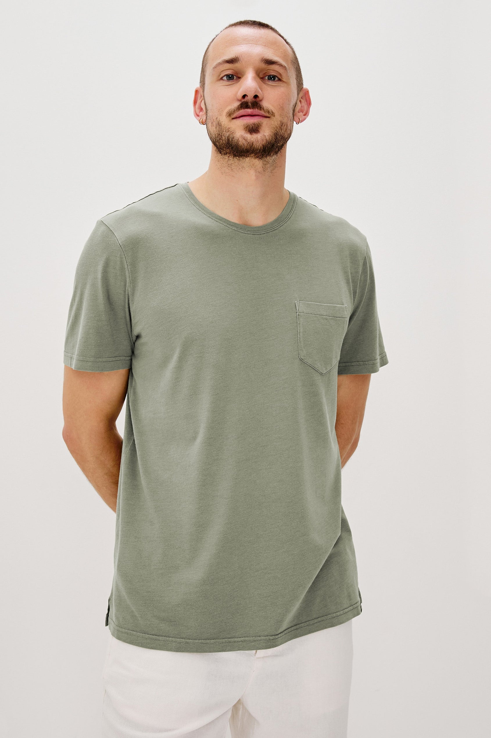 Johnny Short Sleeve T-Shirt with a Crew Neck, Chest Patch Pocket and Small Slits at the Side Hems in Olive Colorway - Front View Featured on Model