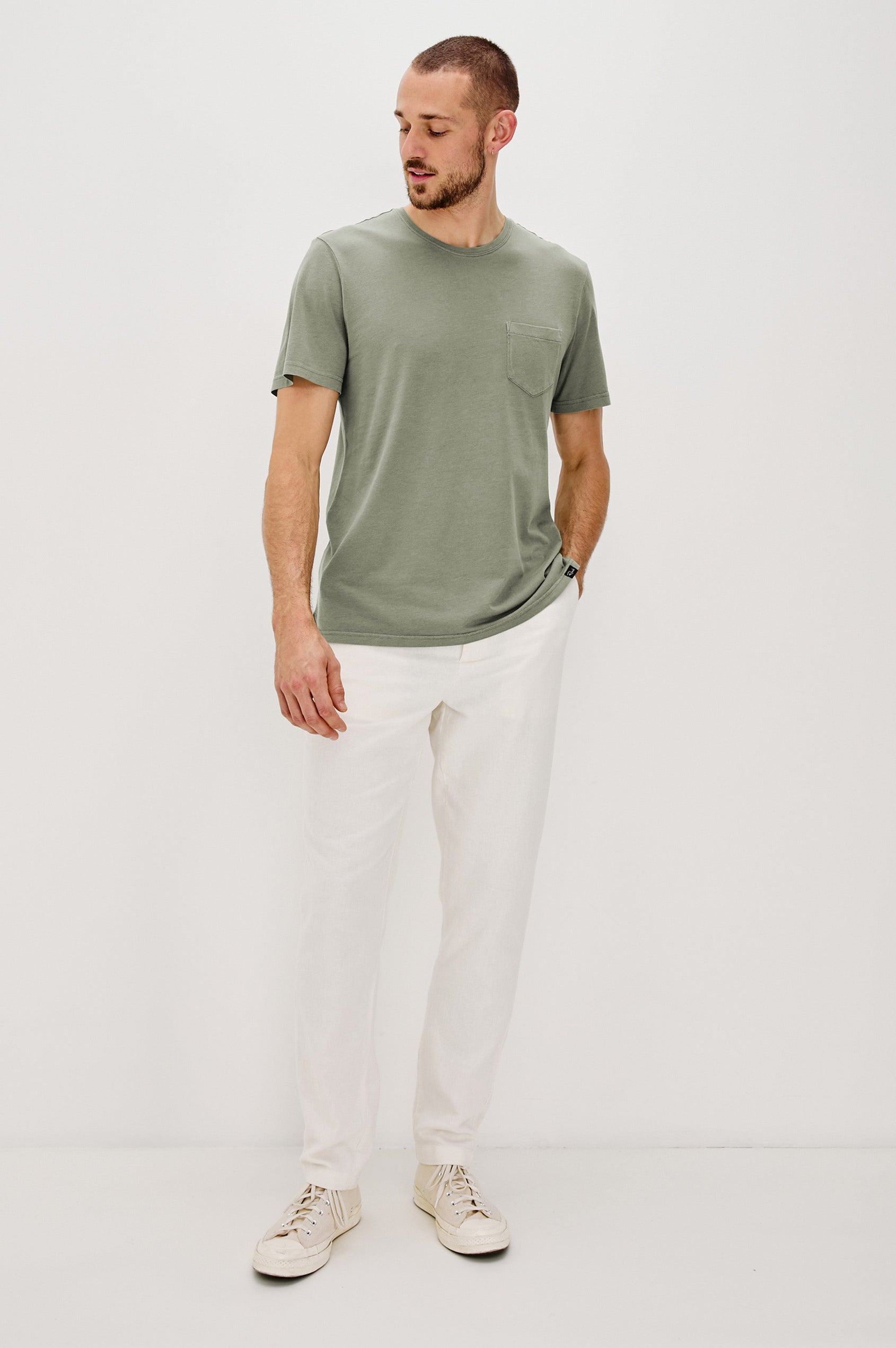 Johnny Short Sleeve T-Shirt with a Crew Neck, Chest Patch Pocket and Small Slits at the Side Hems in Olive Colorway - Full Body Front View Featured on Model