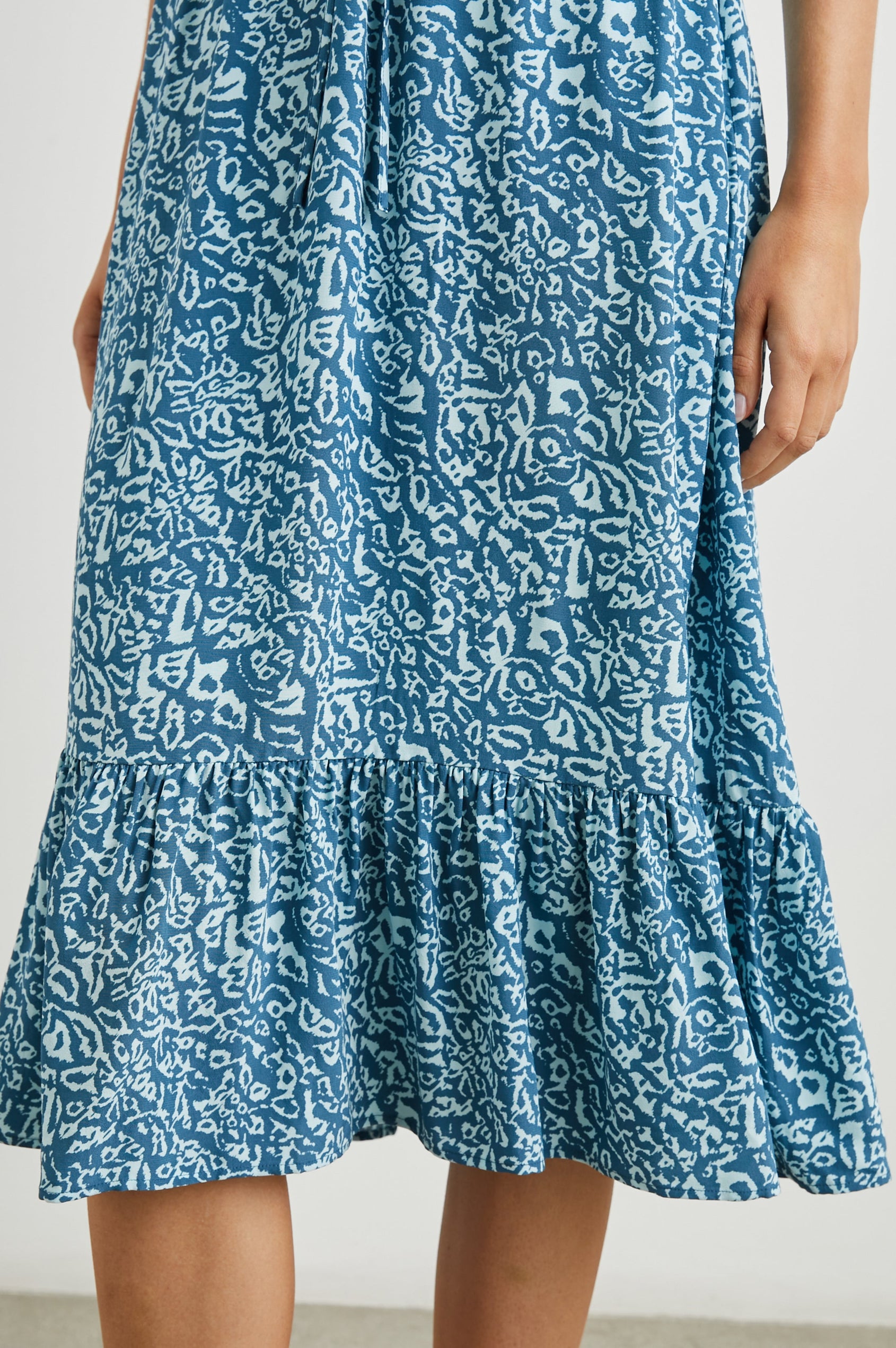 Kiki Short Sleeve Midi Dress with a V Neck, Buttons Down the Front Bodice, a Drawstring Waist and Ruffles at the Hem in Blue Havana Colorway, a Print in Blues - Front View Featured on Model
