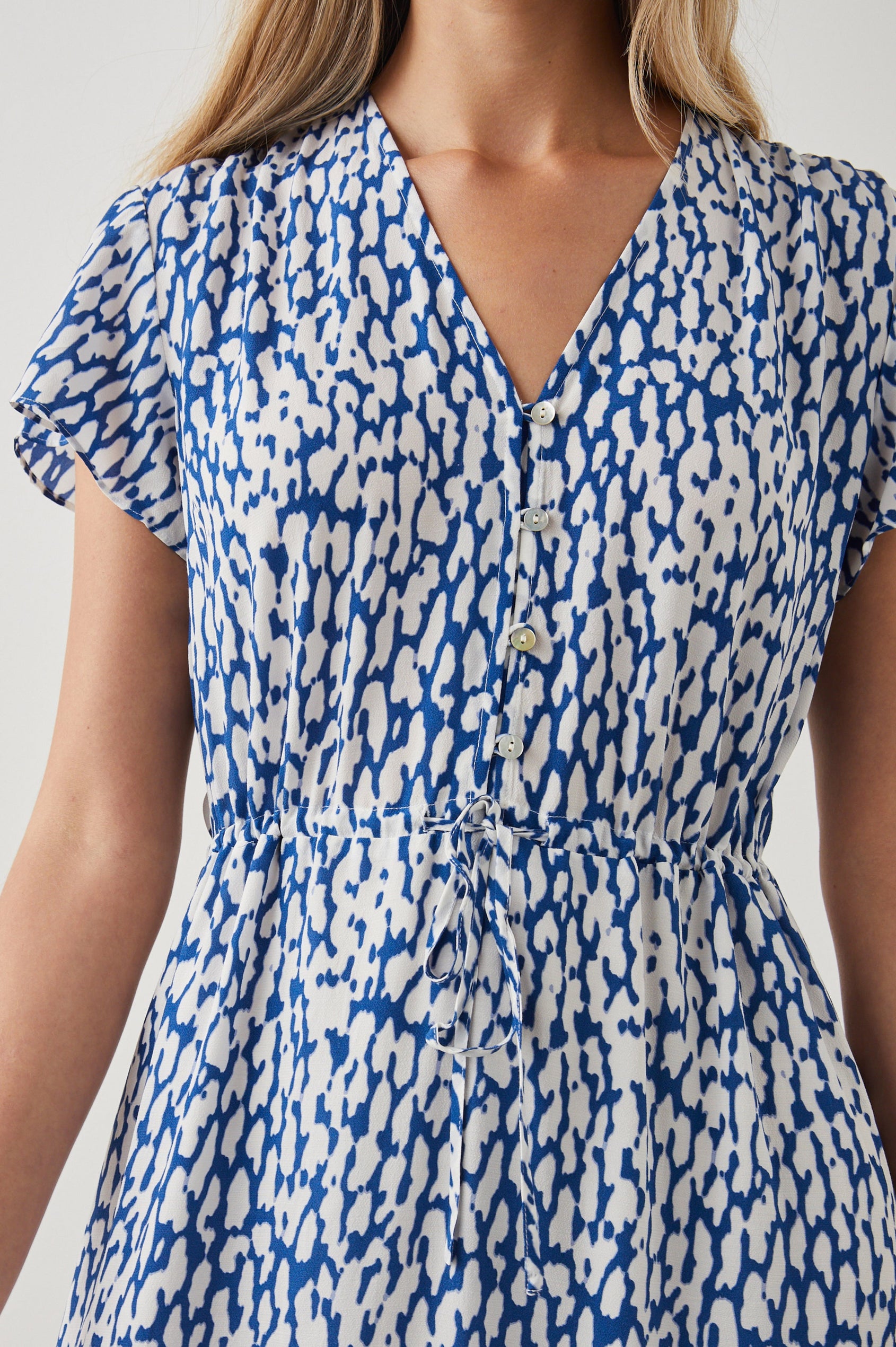Kiki Short Sleeve Midi Dress with a V Neck, Buttons Down the Front Bodice, a Drawstring Waist and Ruffles at the Hem in Cobalt Static Leopard Colorway, a Blue and White Print - Front View Featured on Model