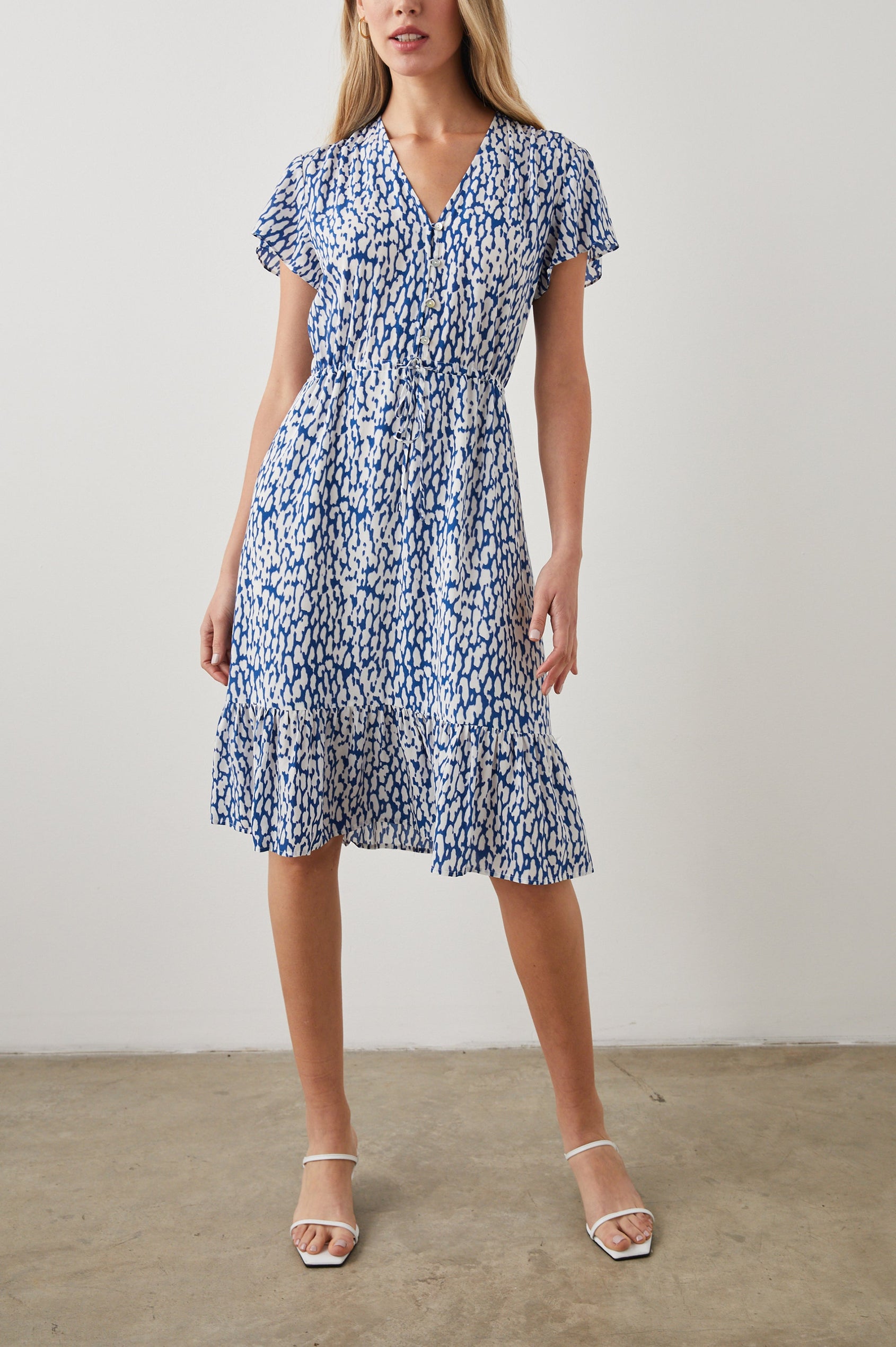 Kiki Short Sleeve Midi Dress with a V Neck, Buttons Down the Front Bodice, a Drawstring Waist and Ruffles at the Hem in Cobalt Static Leopard Colorway, a Blue and White Print - Front Full Body View Featured on Model