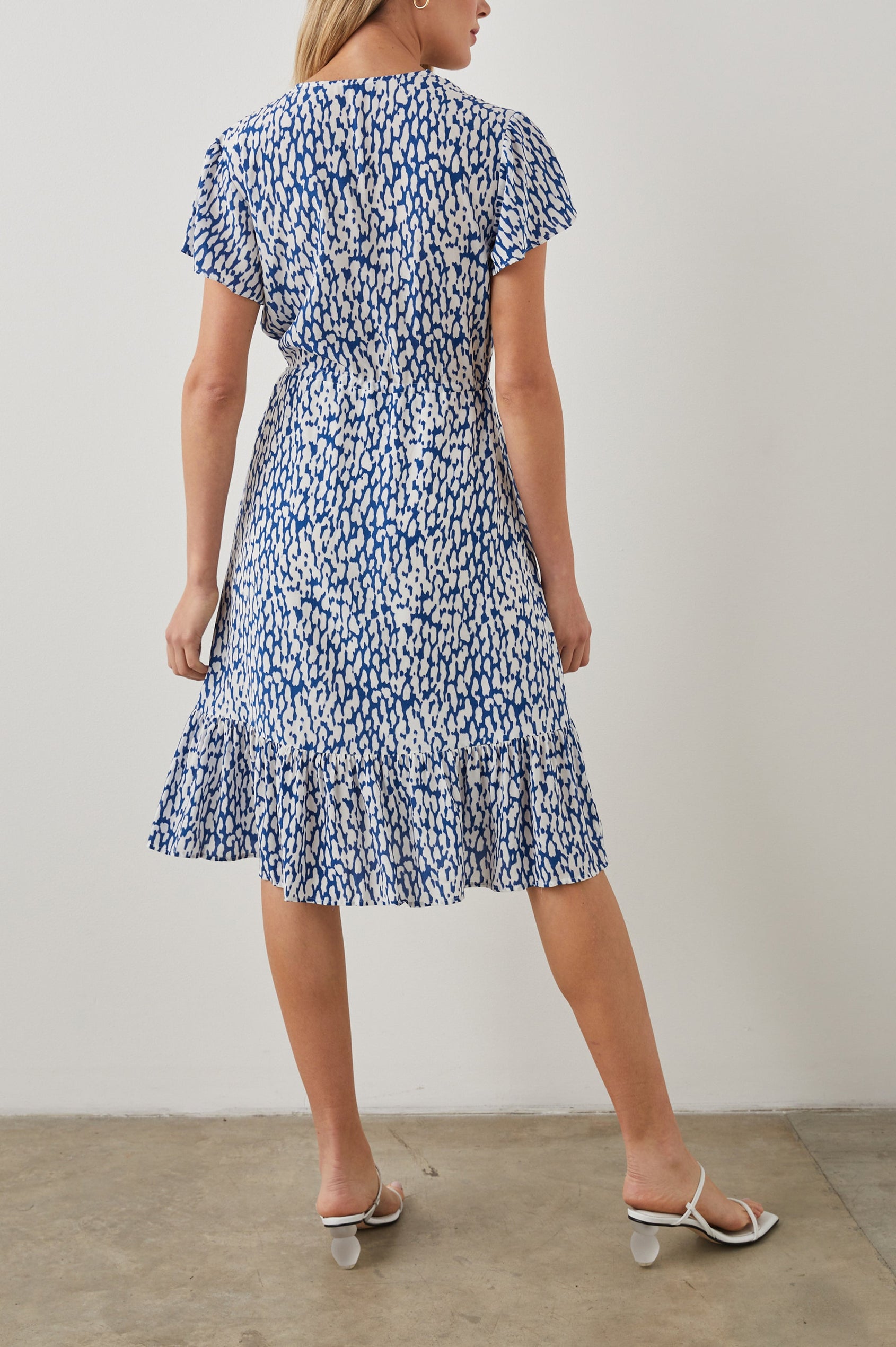 Kiki Short Sleeve Midi Dress with a V Neck, Buttons Down the Front Bodice, a Drawstring Waist and Ruffles at the Hem in Cobalt Static Leopard Colorway, a Blue and White Print - Front Full Body View Featured on Model