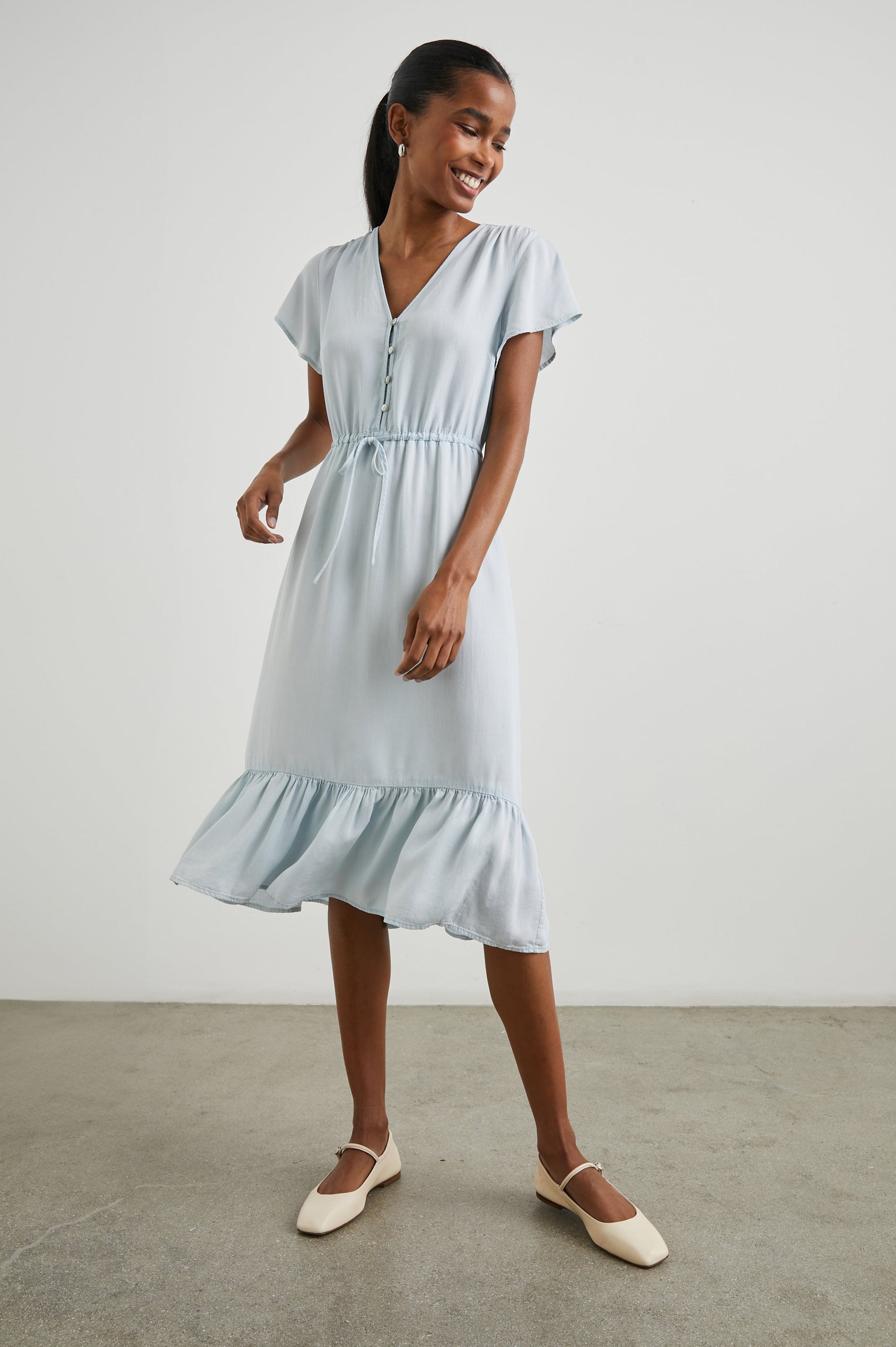 Kiki Short Sleeve Midi Dress with a V Neck, Buttons Down the Front Bodice, a Drawstring Waist and Ruffles at the Hem in Light Vintage Colorway - Front Full Body View Featured on Model