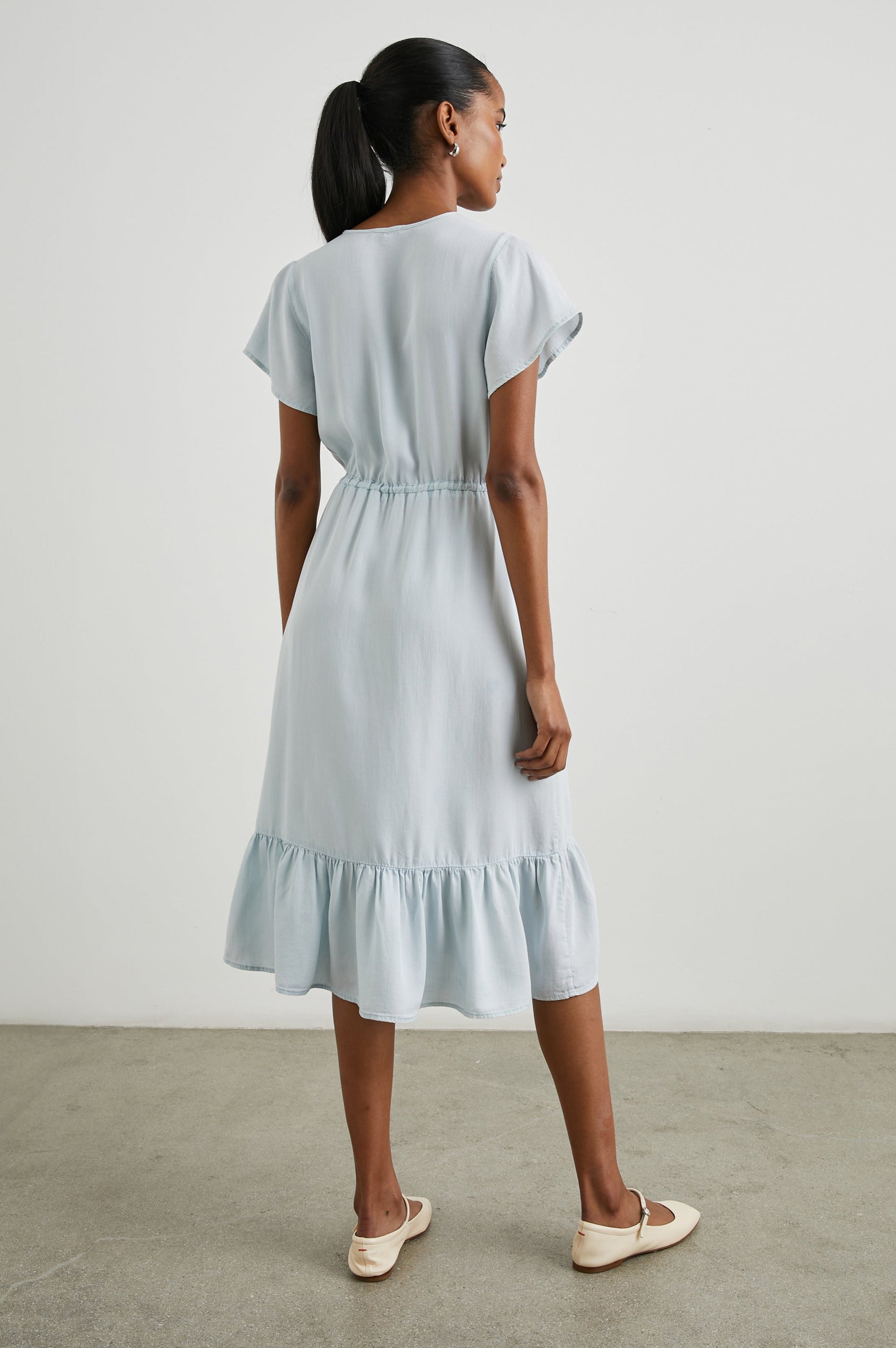 Kiki Short Sleeve Midi Dress with a V Neck, Buttons Down the Front Bodice, a Drawstring Waist and Ruffles at the Hem in Light Vintage Colorway - Back Full Body View Featured on Model