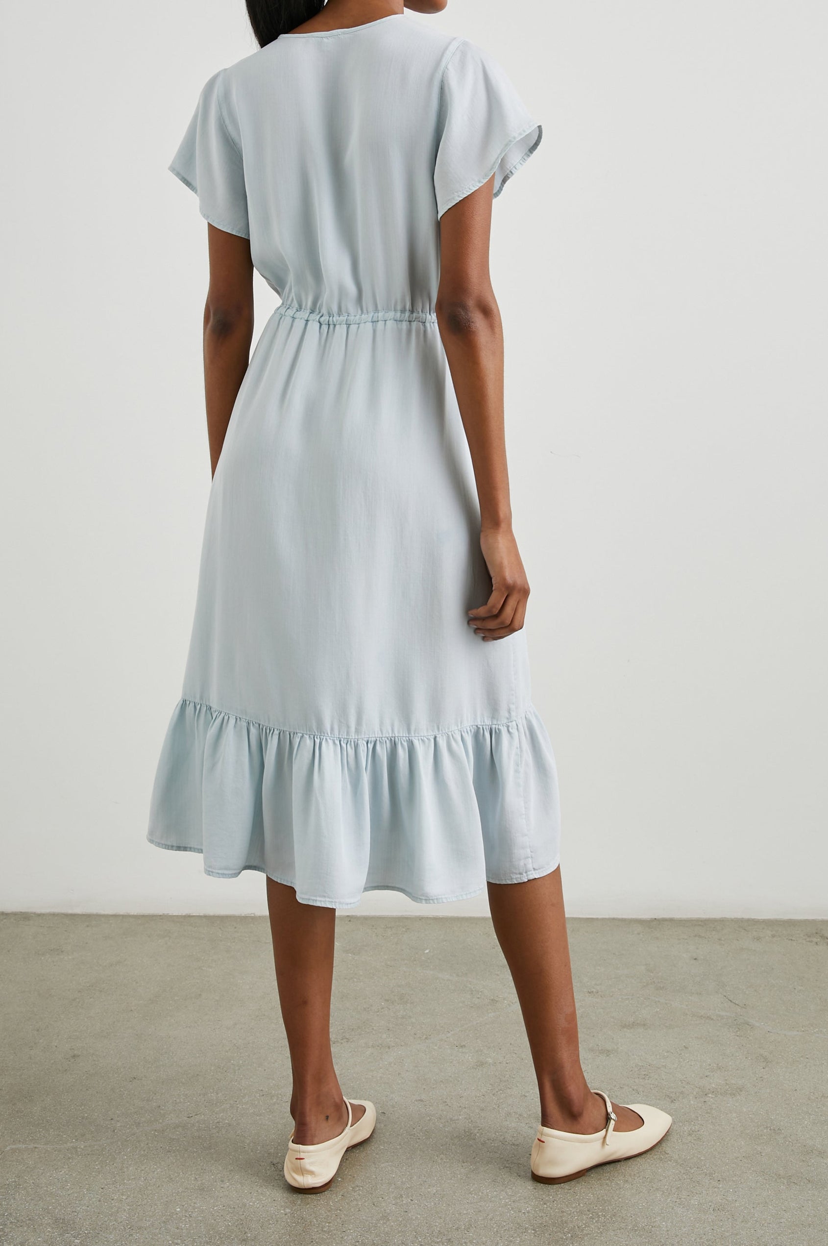 Kiki Short Sleeve Midi Dress with a V Neck, Buttons Down the Front Bodice, a Drawstring Waist and Ruffles at the Hem in Light Vintage Colorway - Back Full Body View Featured on Model