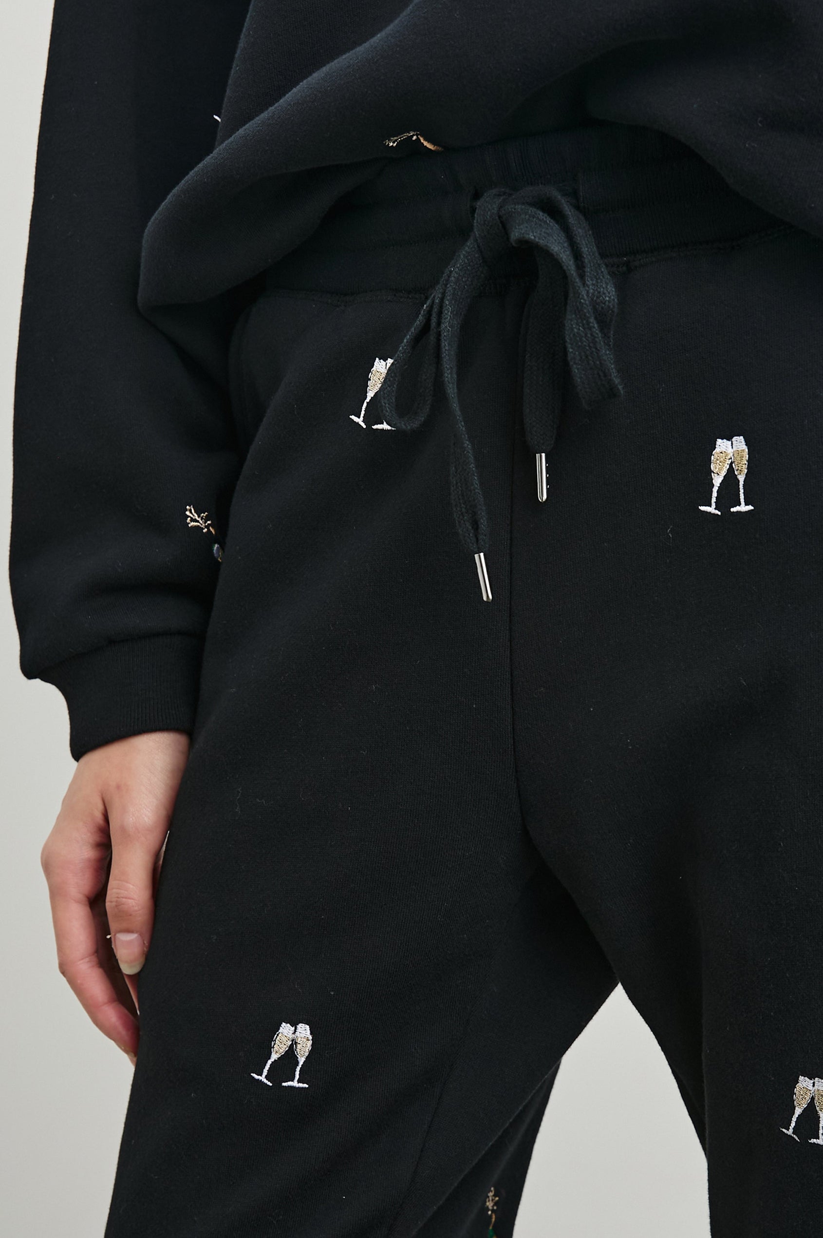 Kingston Pants with Elastic Cuffs and Waist with Drawcord in Black Champagne Embroidery Colorway, Champagne Glasses on Black - Front View Featured on Model