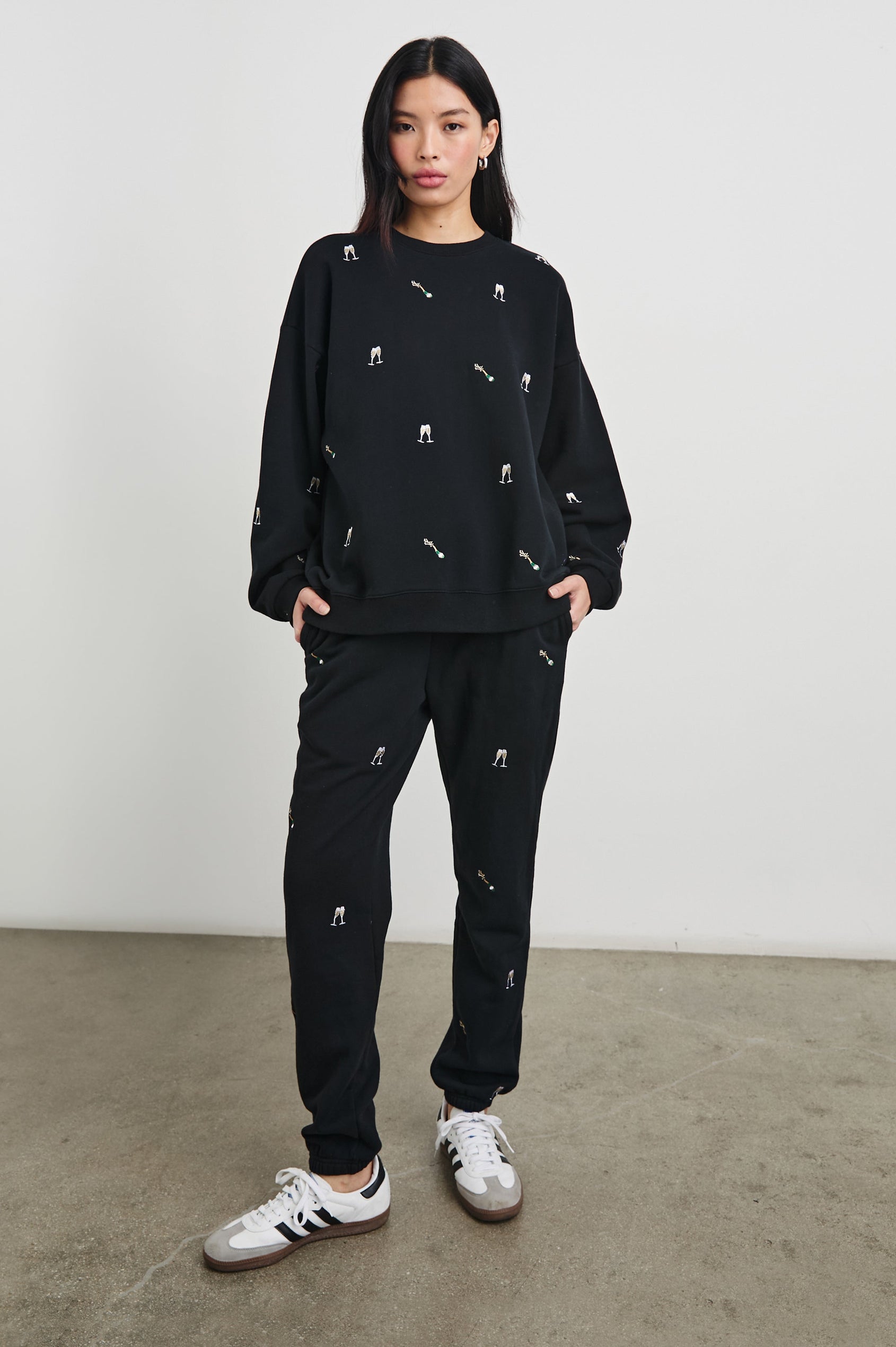 Kingston Pants with Elastic Cuffs and Waist with Drawcord in Black Champagne Embroidery Colorway, Champagne Glasses on Black - Front Full Body View Featured on Model