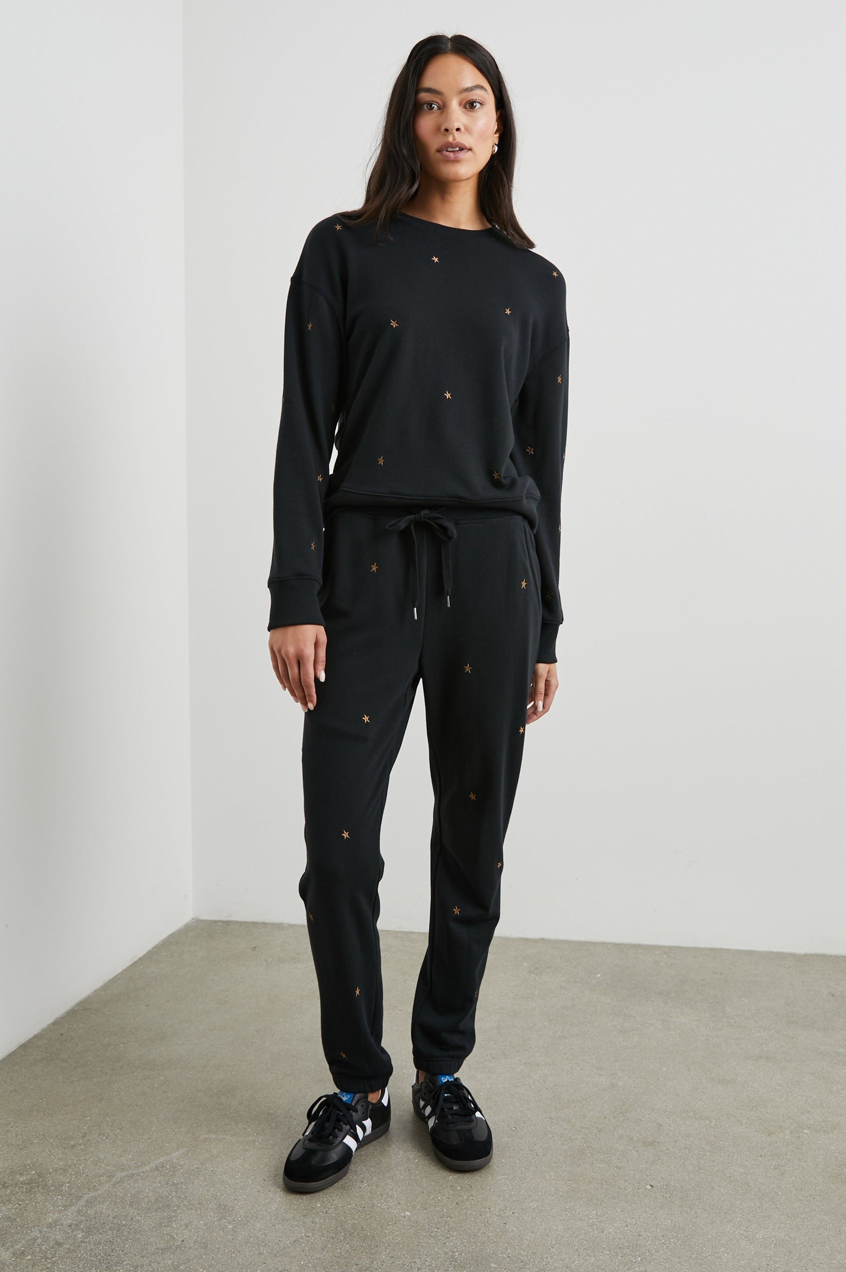Kingston Sweatpants with Elastic Cuffs and Waist with Drawcord in Bronze Star Embroidery Colorway, Bronze Stars on Black - Front Full Body View Featured on Model