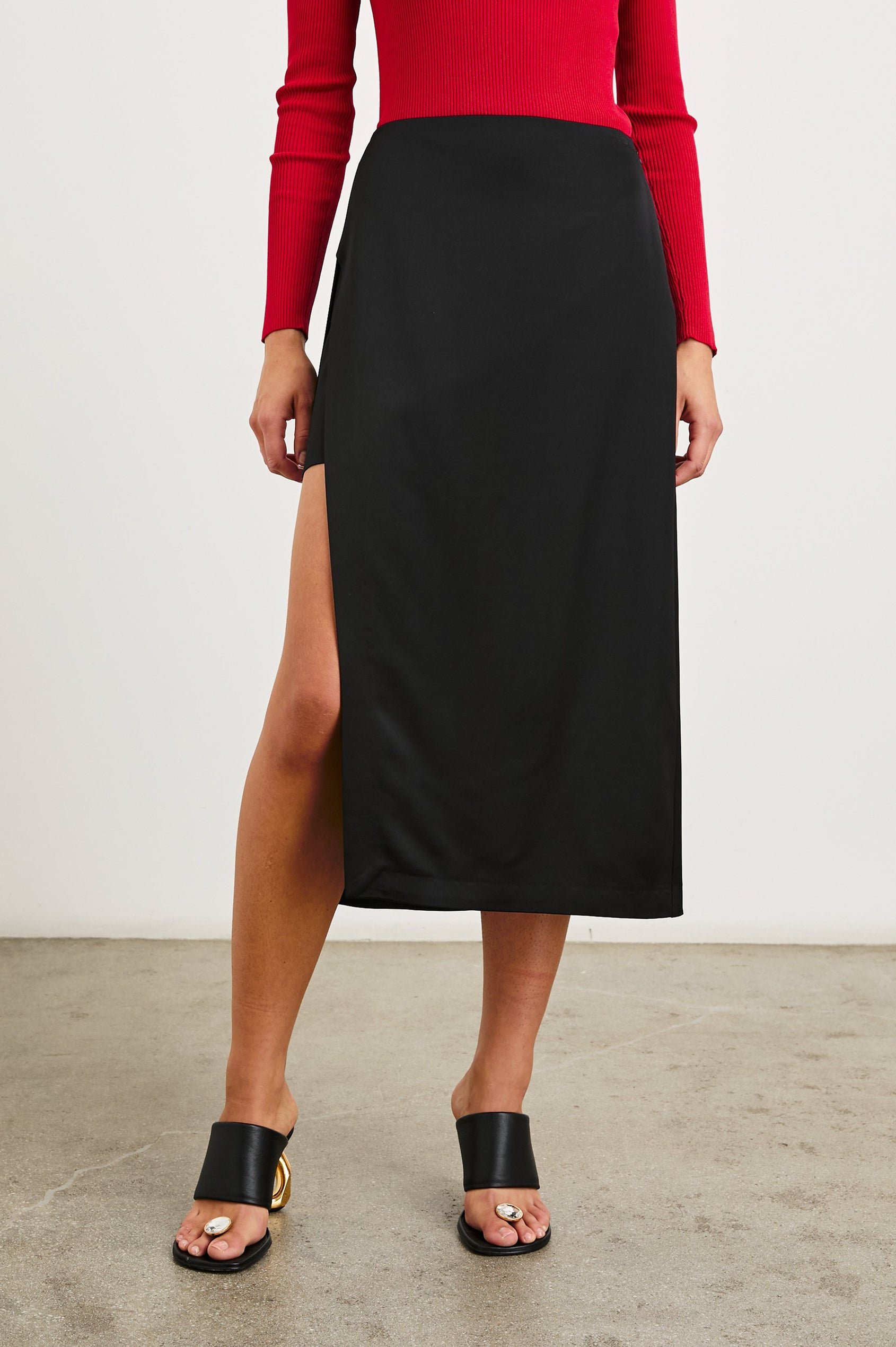 Kira Midi Skirt with a Side Slit and an Inner Midi Skirt in Black Colorway - Front View Featured on Model