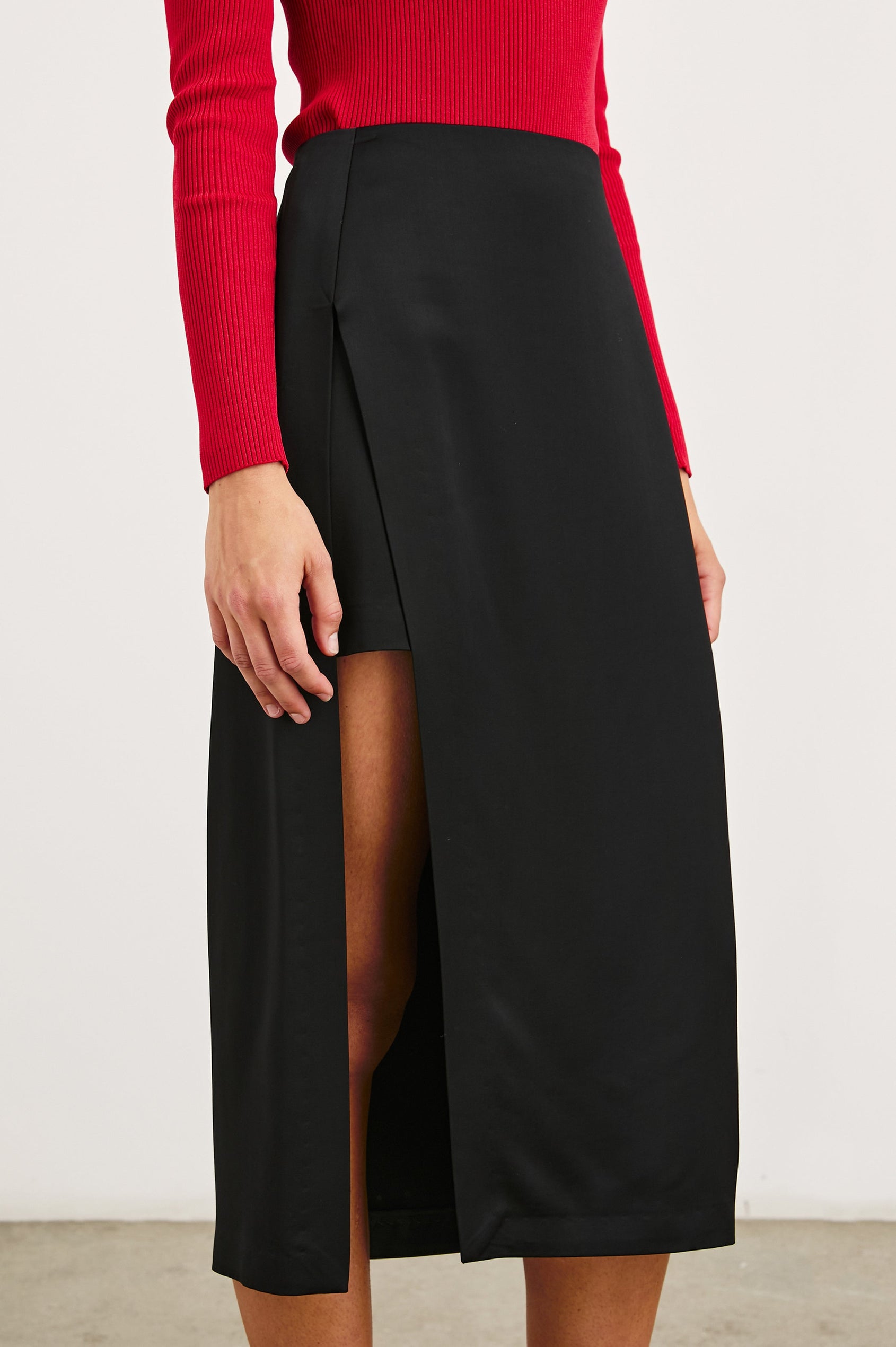 Kira Midi Skirt with a Side Slit and an Inner Midi Skirt in Black Colorway - Front View Featured on Model