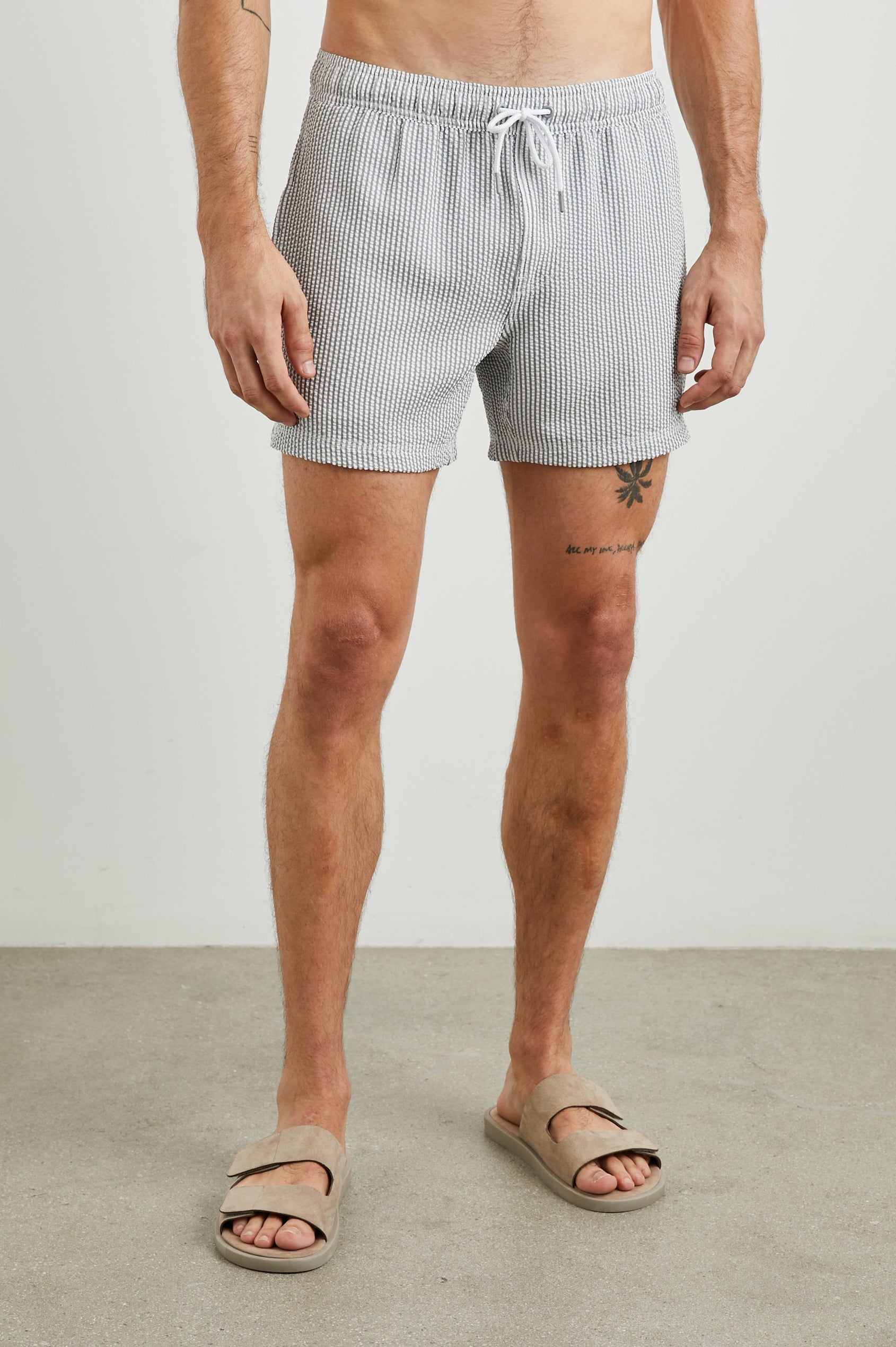 La Brea Swim Shorts with a Drawstring Waist, Two Front Pockets and a Back Patch Pocket in Faded Seersucker Colorway, Grey and white thin vertical stripes - Front View Featured on Model