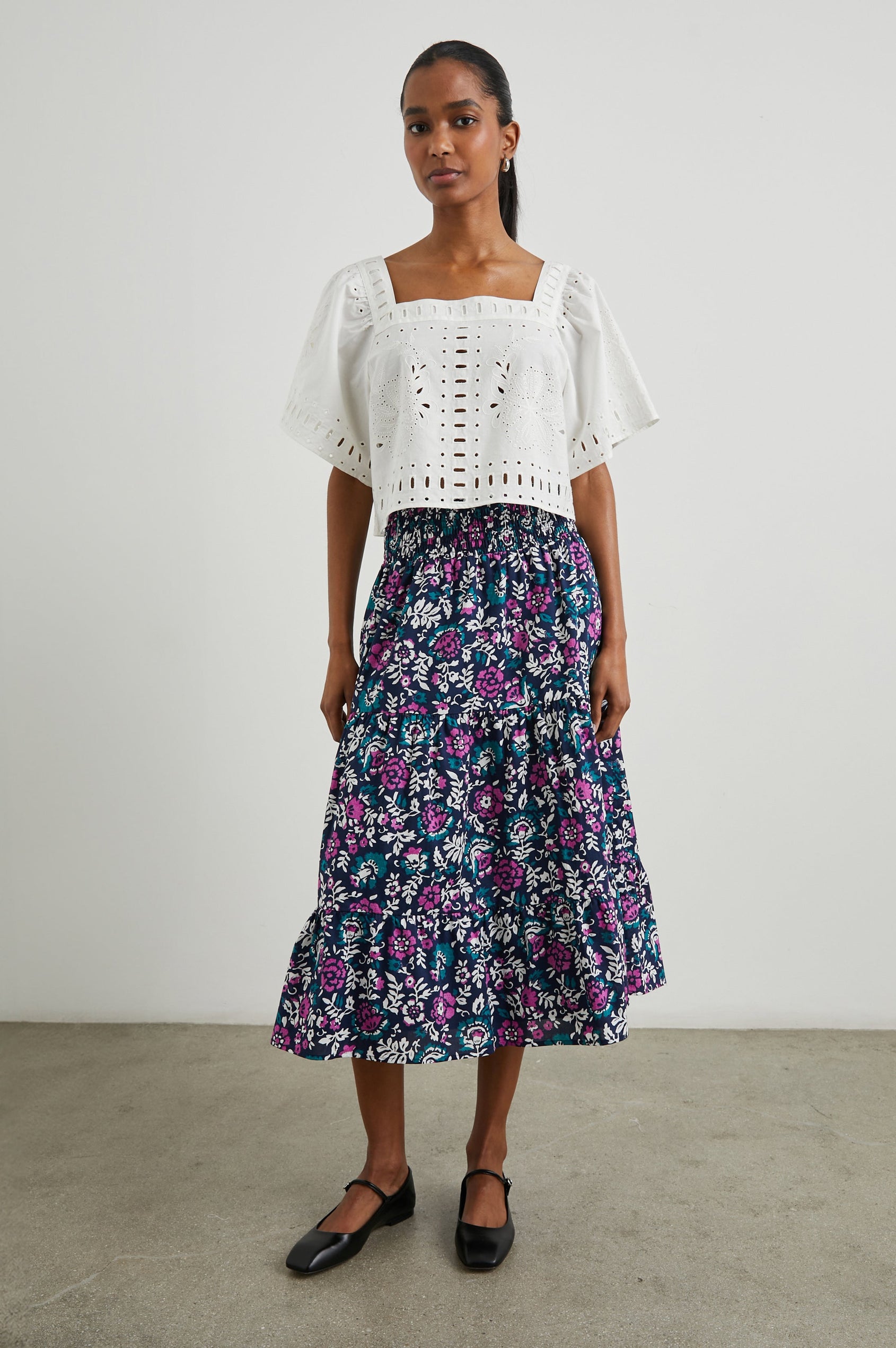 Laine Short Sleeve Crop Top with Square Neckline, and a Floral and Geometric Eyelet Design in White Colorway - Front Full Body View Featured on Model