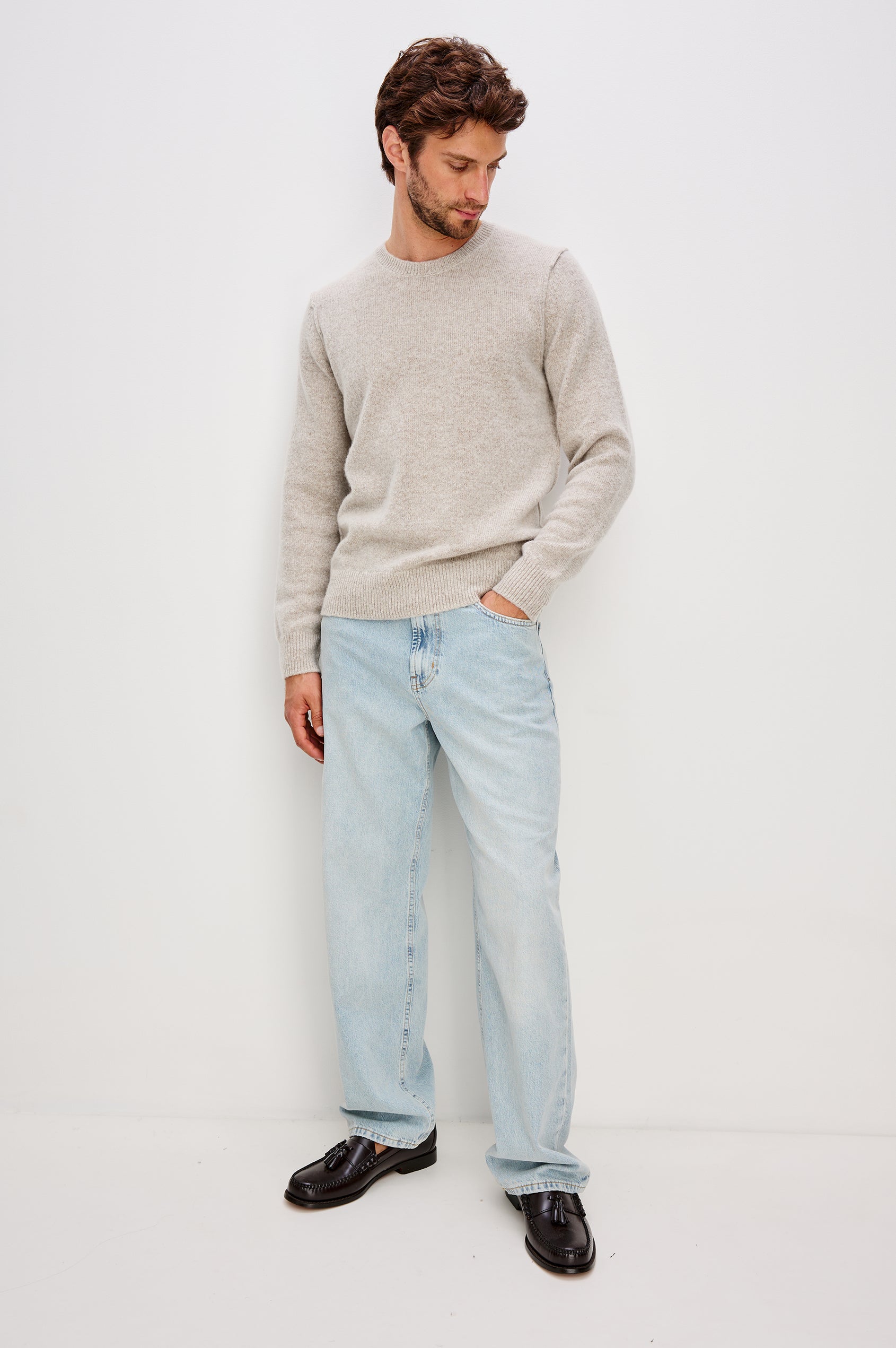 Laurent is a relaxed-fit crewneck sweater, dropped shoulders, long sleeves, and linking-stitch detailing at the shoulders in Silverleaf colorway. Front full body view featured on model.