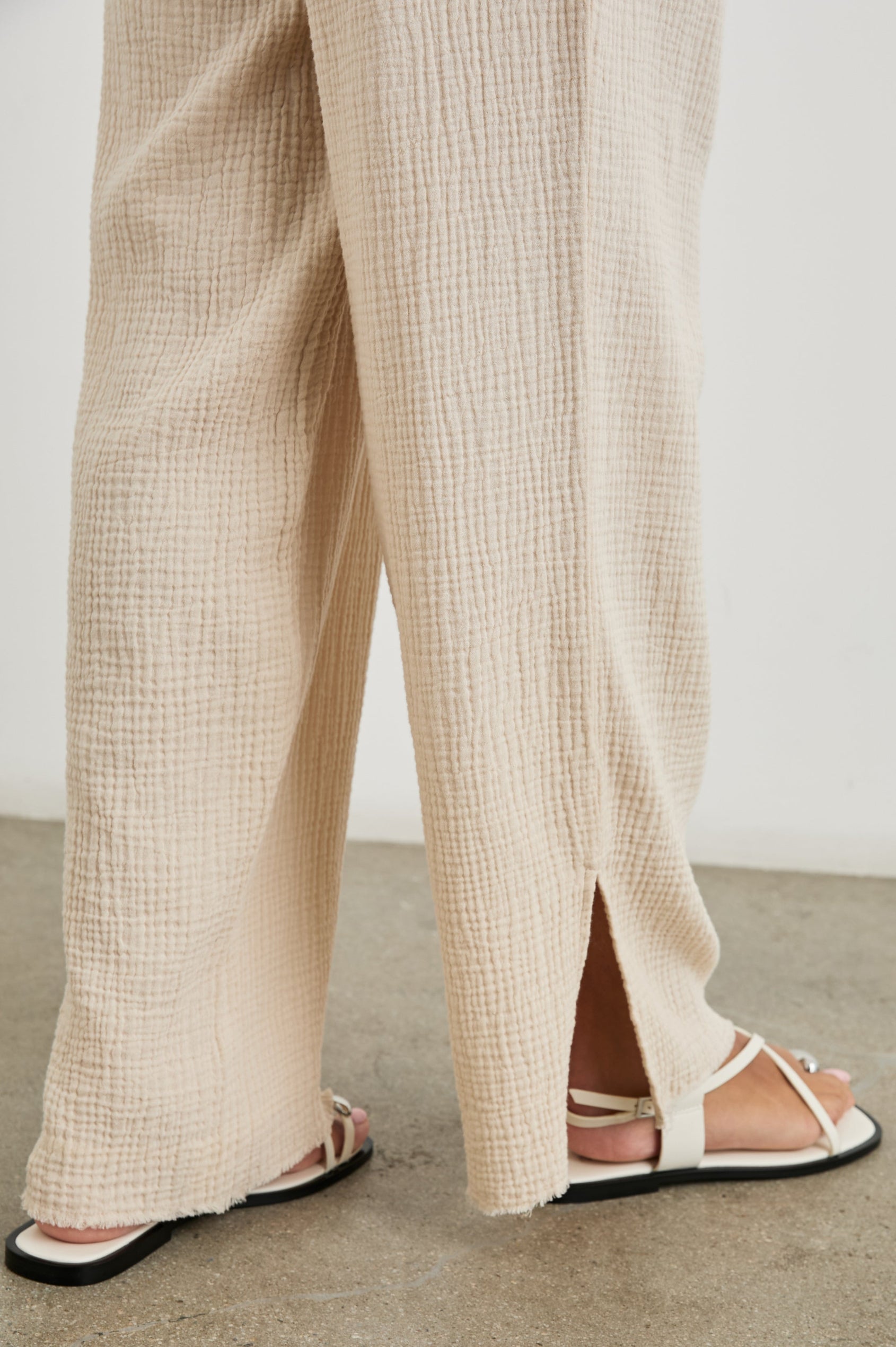 Leon Cotton Gauze Pant With Hemline Slit And Elastic Waist In Colorway Flax - Detail View Featured On Model