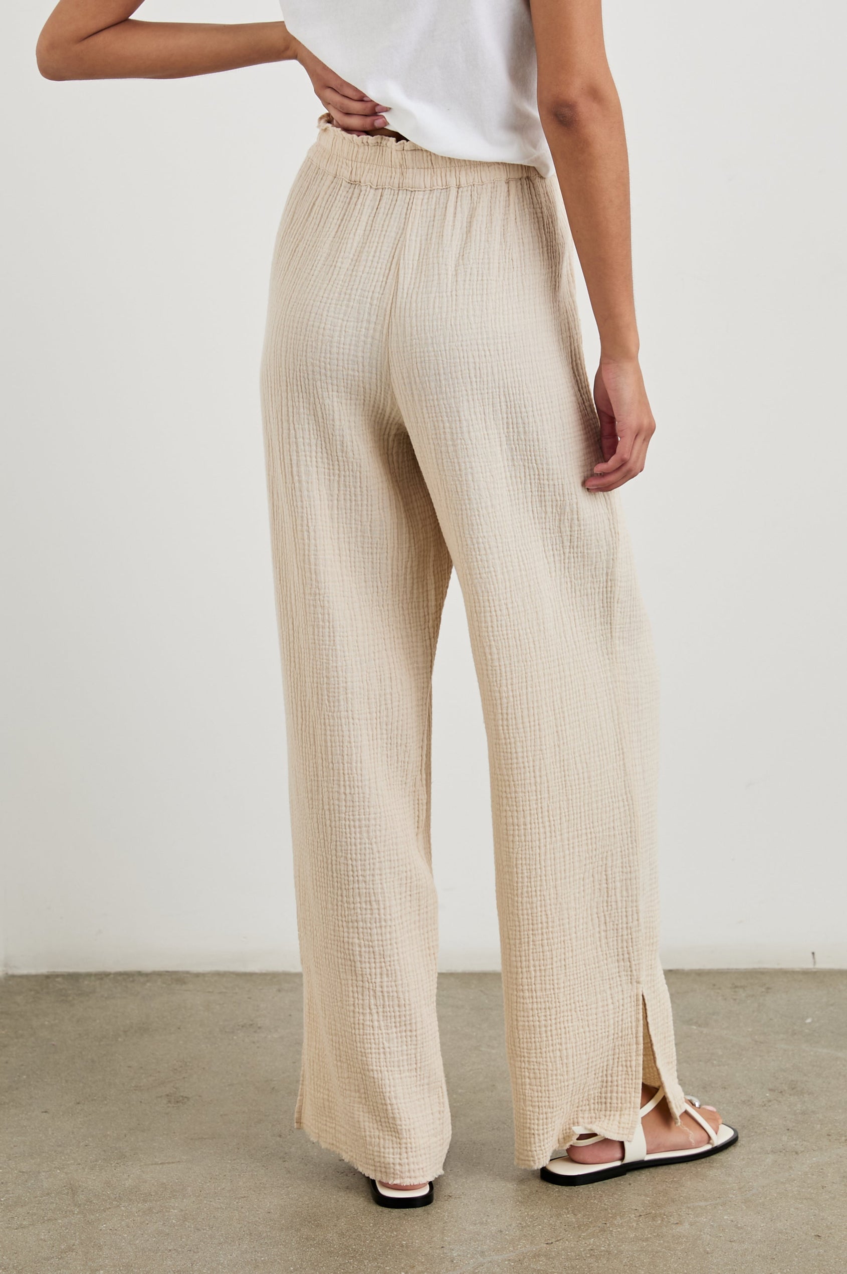 Leon Cotton Gauze Pant With Hemline Slit And Elastic Waist In Colorway Flax - Back View Featured On Model