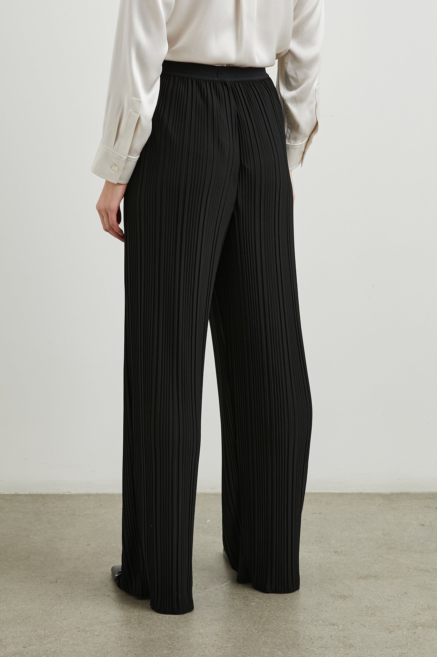 Liana Micro-Pleated Pants with an Elastic Waist in Jet Colorway - Back View Featured on Model