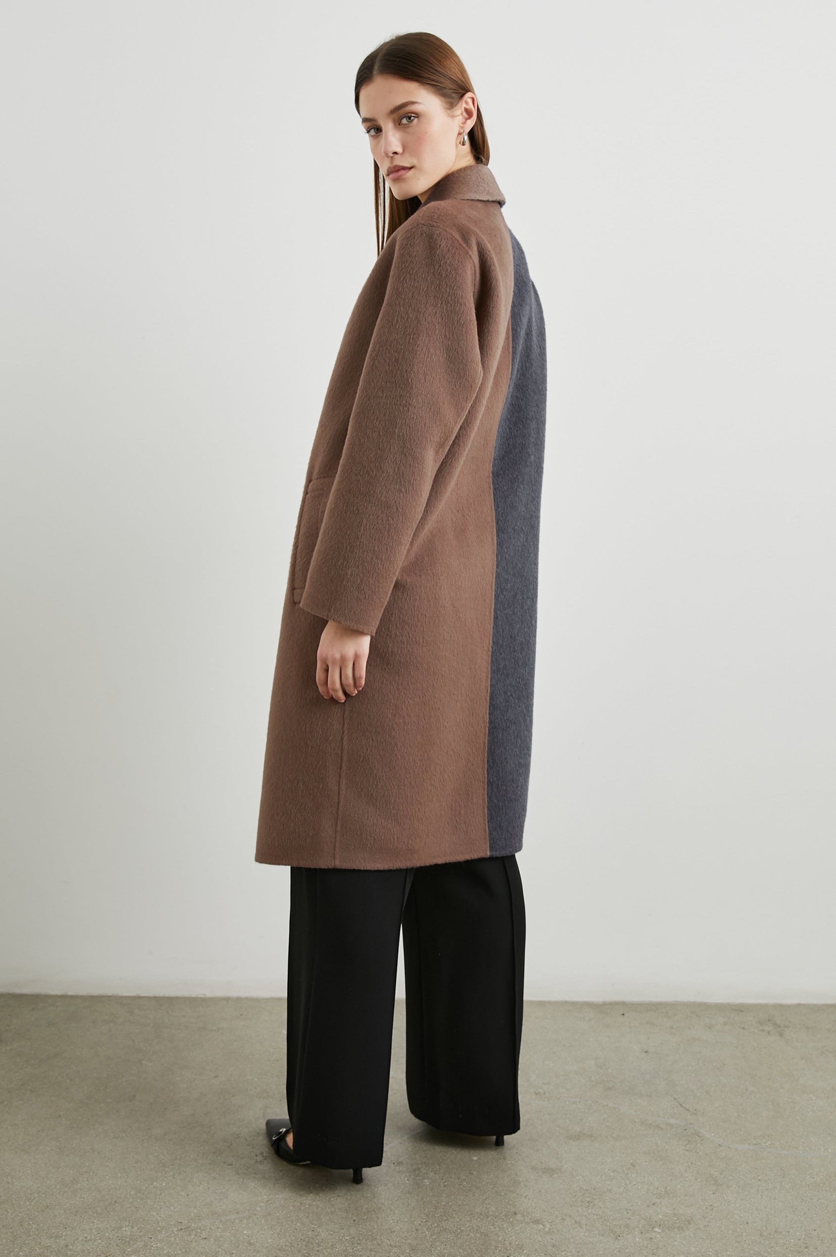 Lore Knee-Length Coat with Two Button Closure, Notched Lapels and Two Front Pockets in Charcoal Mink Mix Colorway, Left Half of Jacket is Mink and the Right Half is Charcoal - Side Full Body View Featured on Model