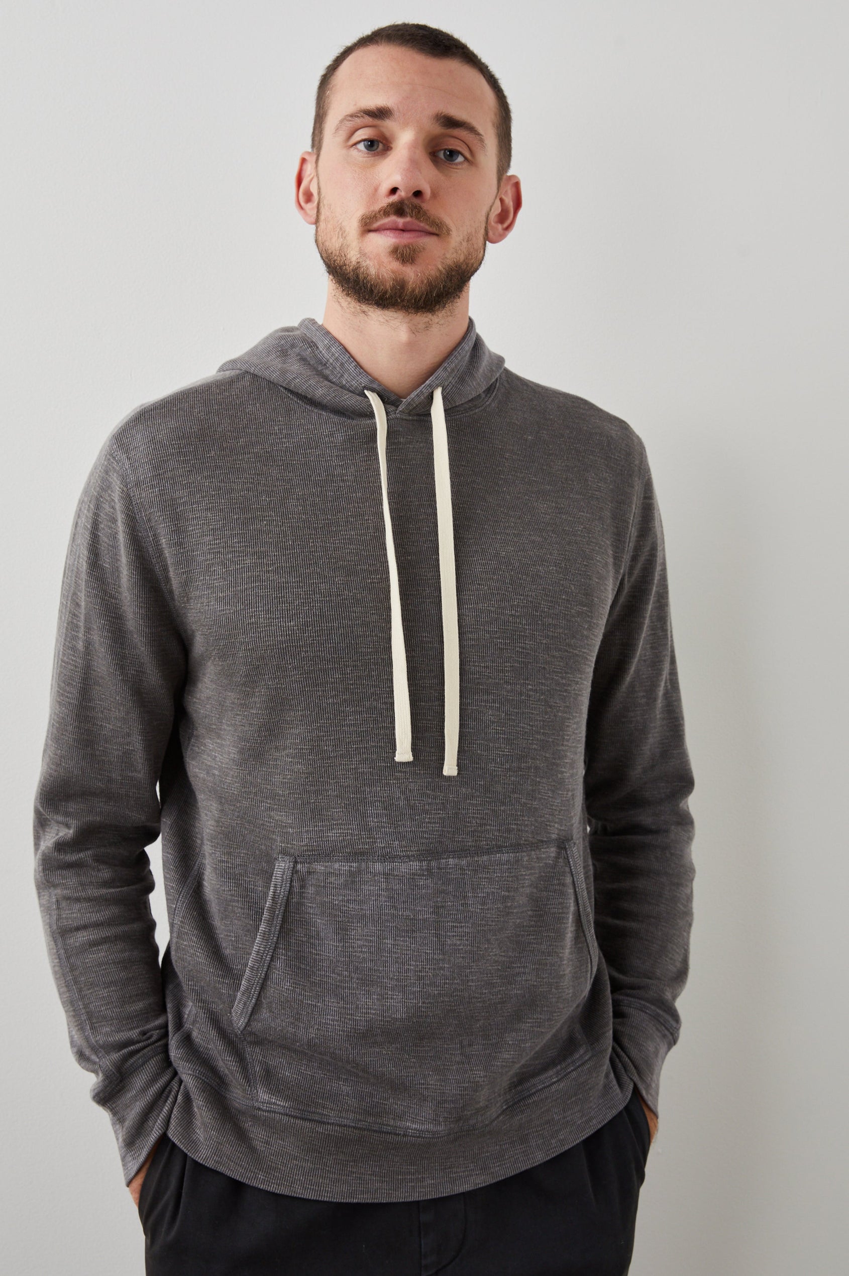 Mammoth Long-Sleeve Hoodie with a Kangaroo Pocket and Drawstring Hood in Washed Black Colorway - Front View Featured on Model
