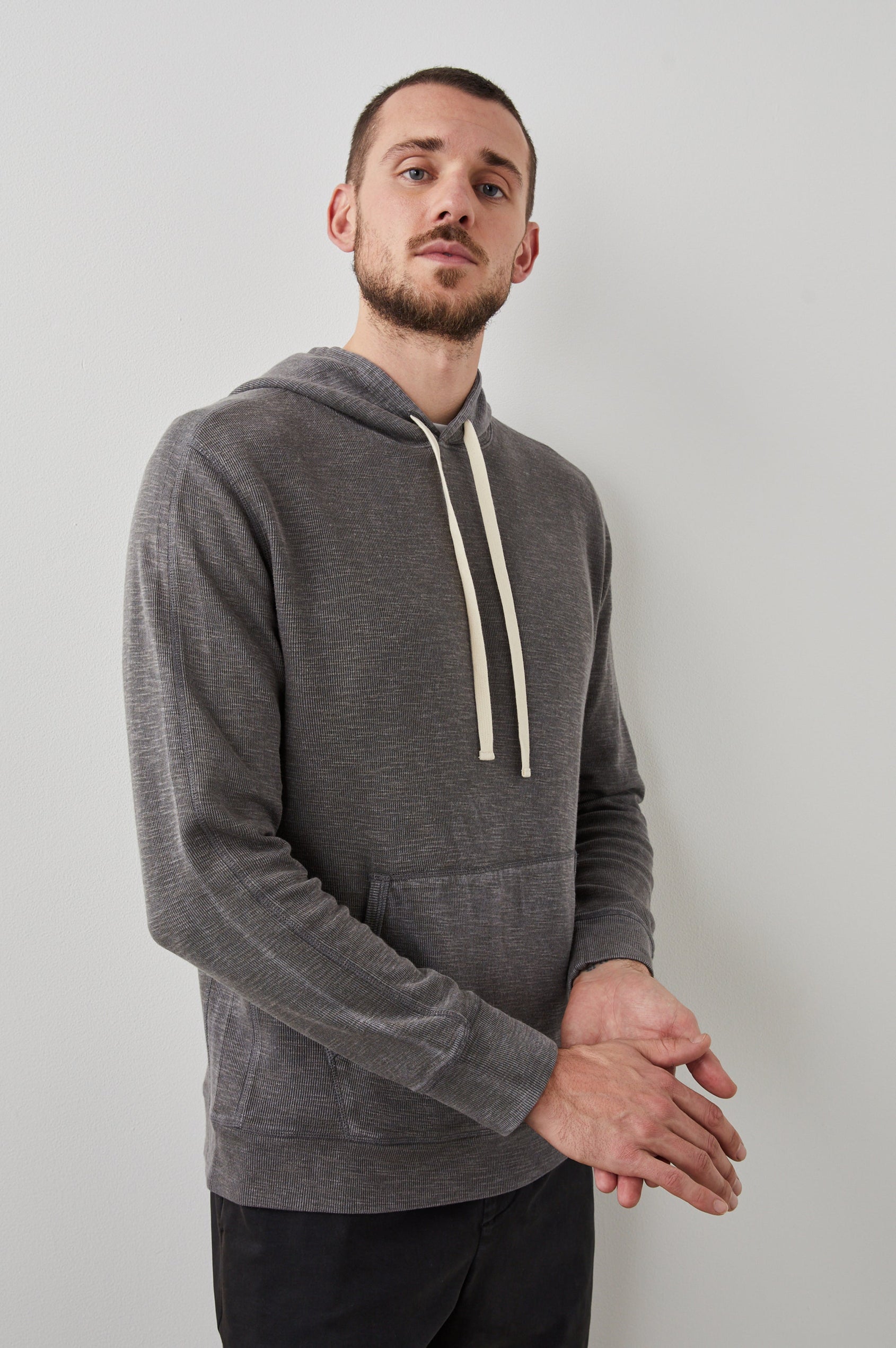 Mammoth Long-Sleeve Hoodie with a Kangaroo Pocket and Drawstring Hood in Washed Black Colorway - Front View Featured on Model