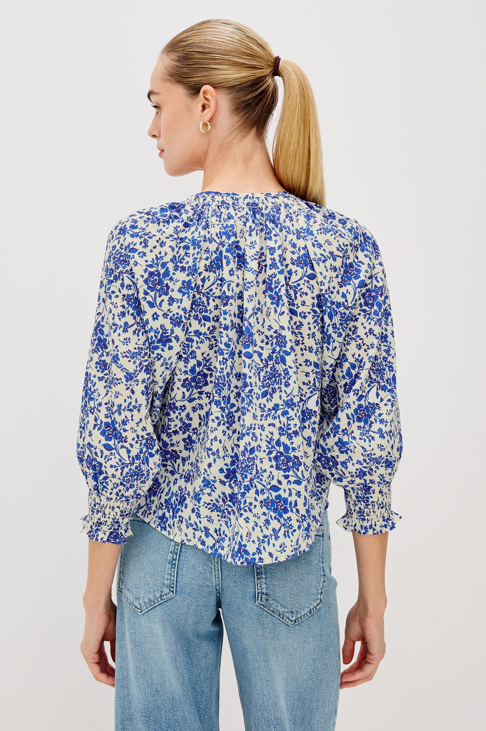 Mariah Button Down Shirt With 3/4" Length Sleeves with Elastic Smoking at Sleeve Hem, V-Neck and Half Button Front in Blue Marguerite Colorway - Back View Featured on Model.