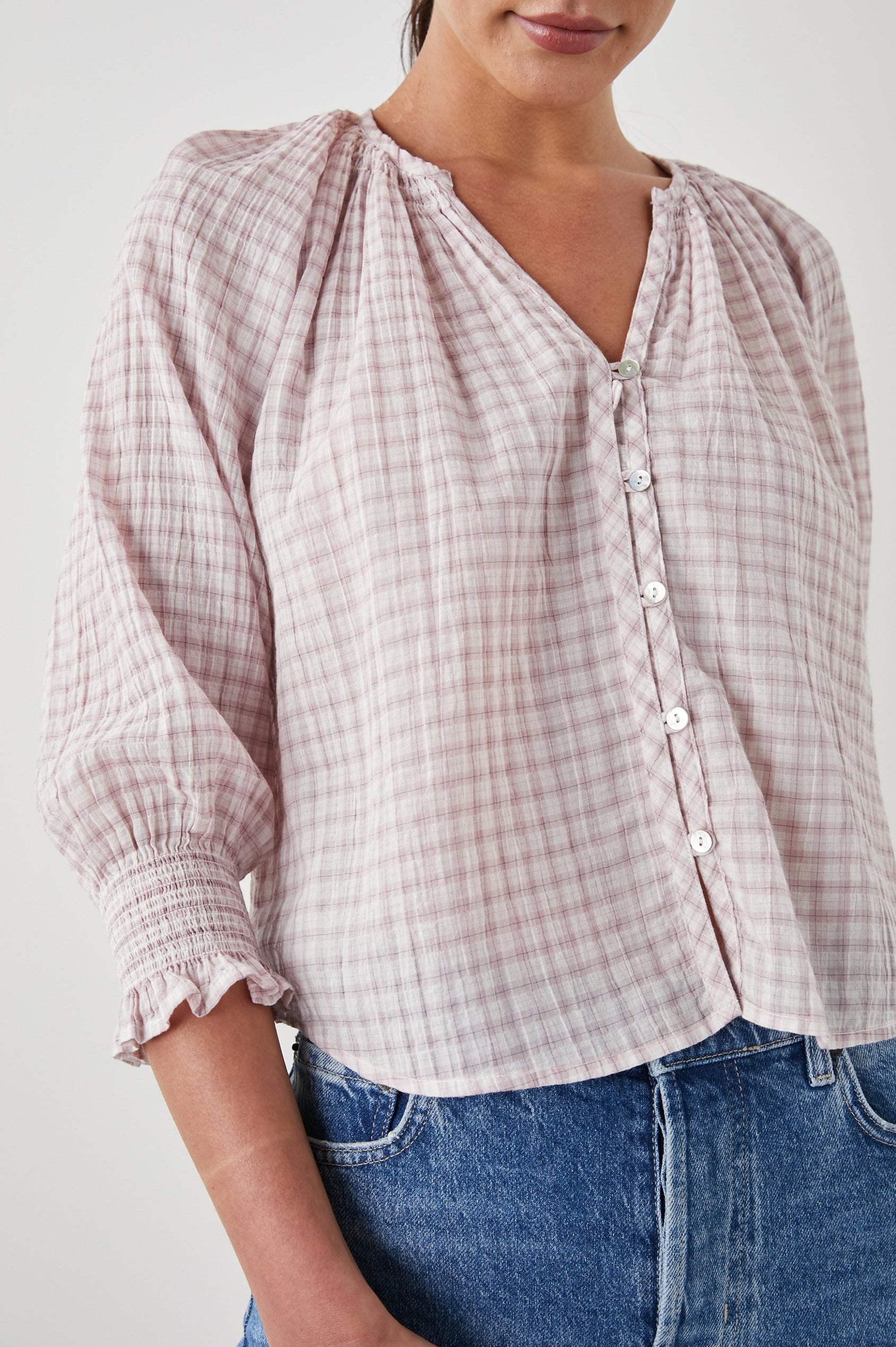 Mariah Top with Three-Quarter Sleeves, Shirred Cuffs, V-Neckline, and Buttons Down the Front in Soft Rose Check Colorway, a White and Rose Plaid - Front View Featured on Model