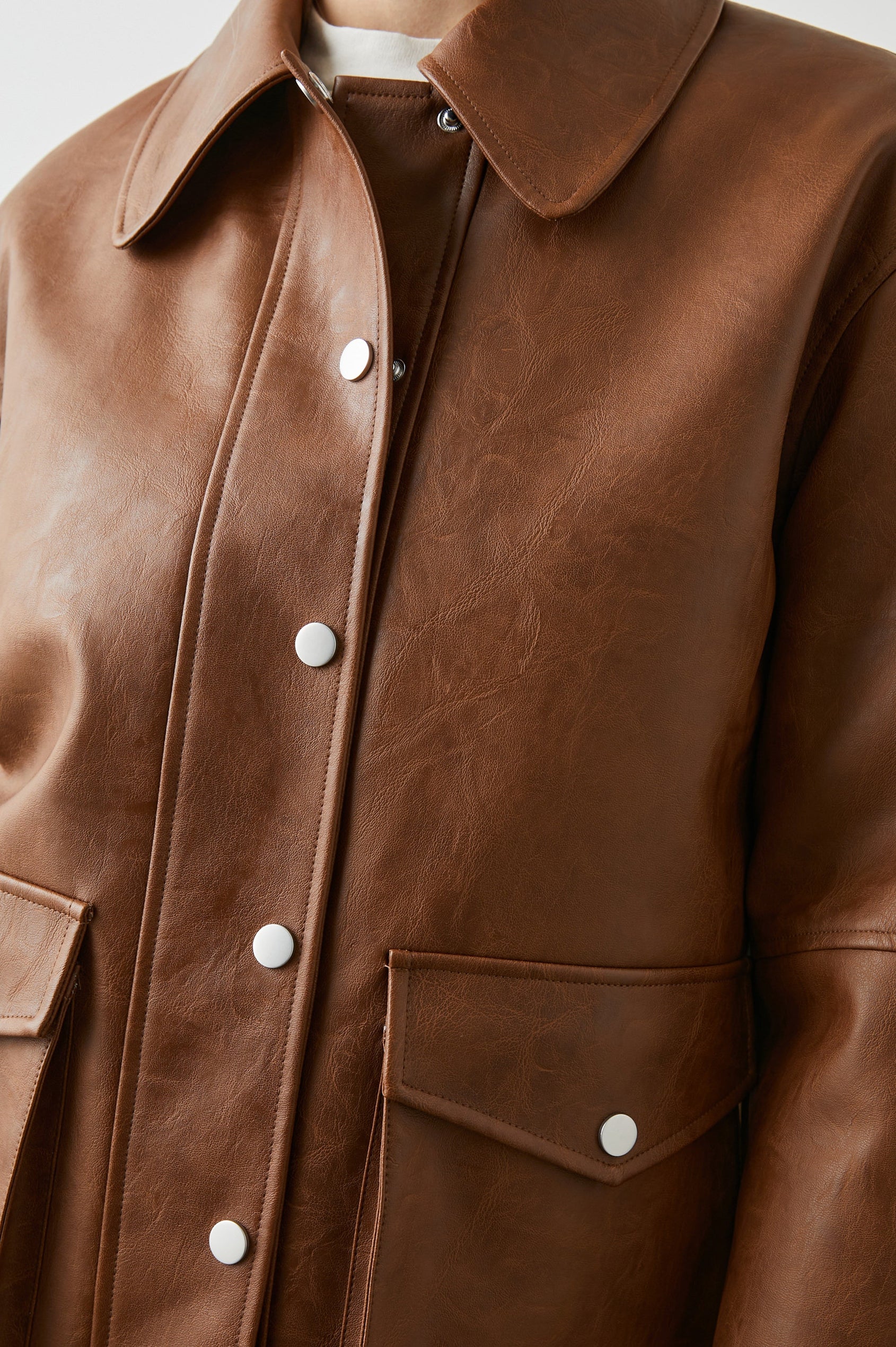 Mathis Faux Leather Jacket with Snap Closure and Two Front Snap Flap Pockets in Russet Colorway - Front View Featured on Model