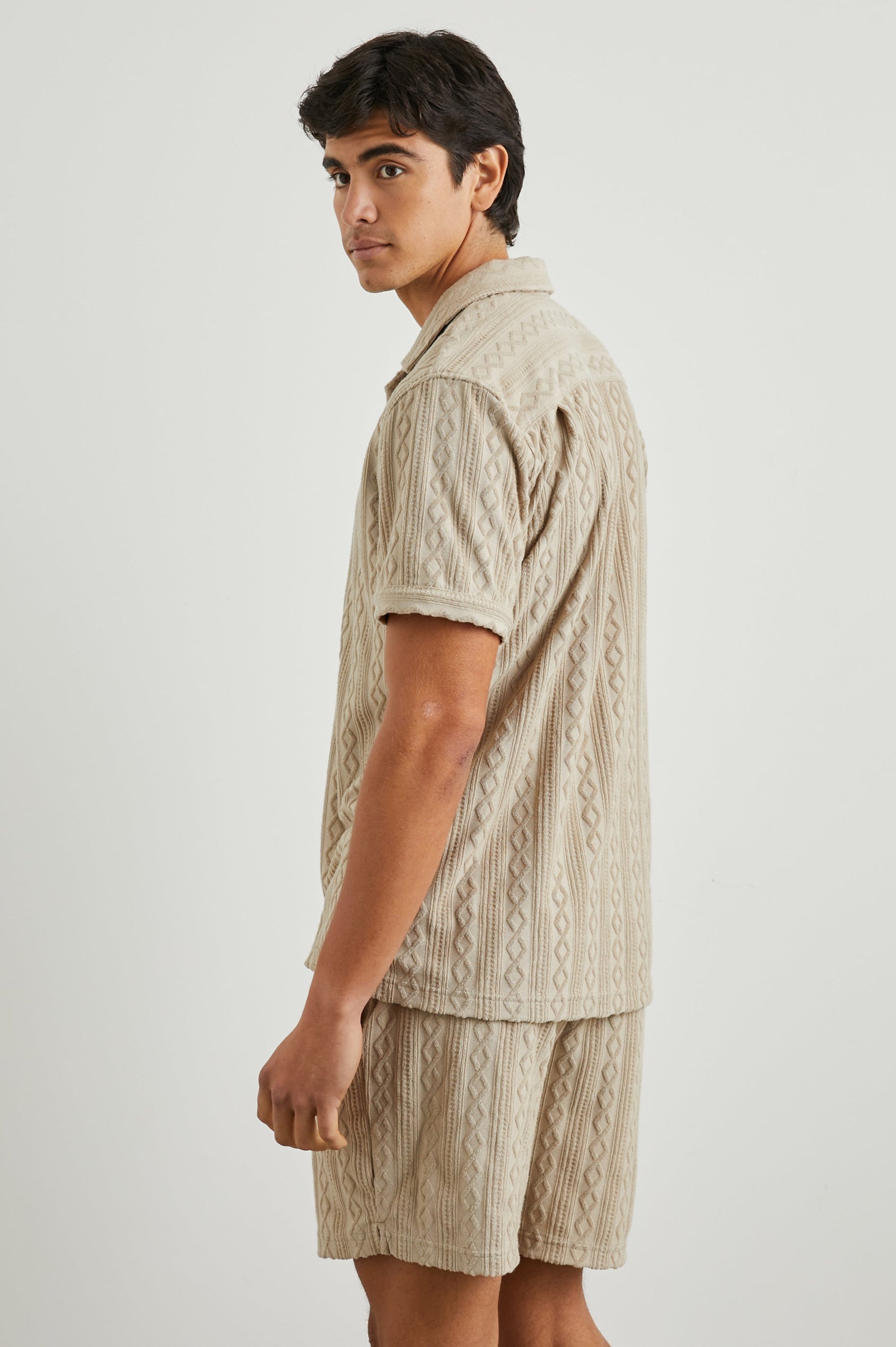 Maverick Short Sleeve Button Up with a raised jacquard pattern in Craft Paper Colorway, a Light Brown - Side View Featured on Model