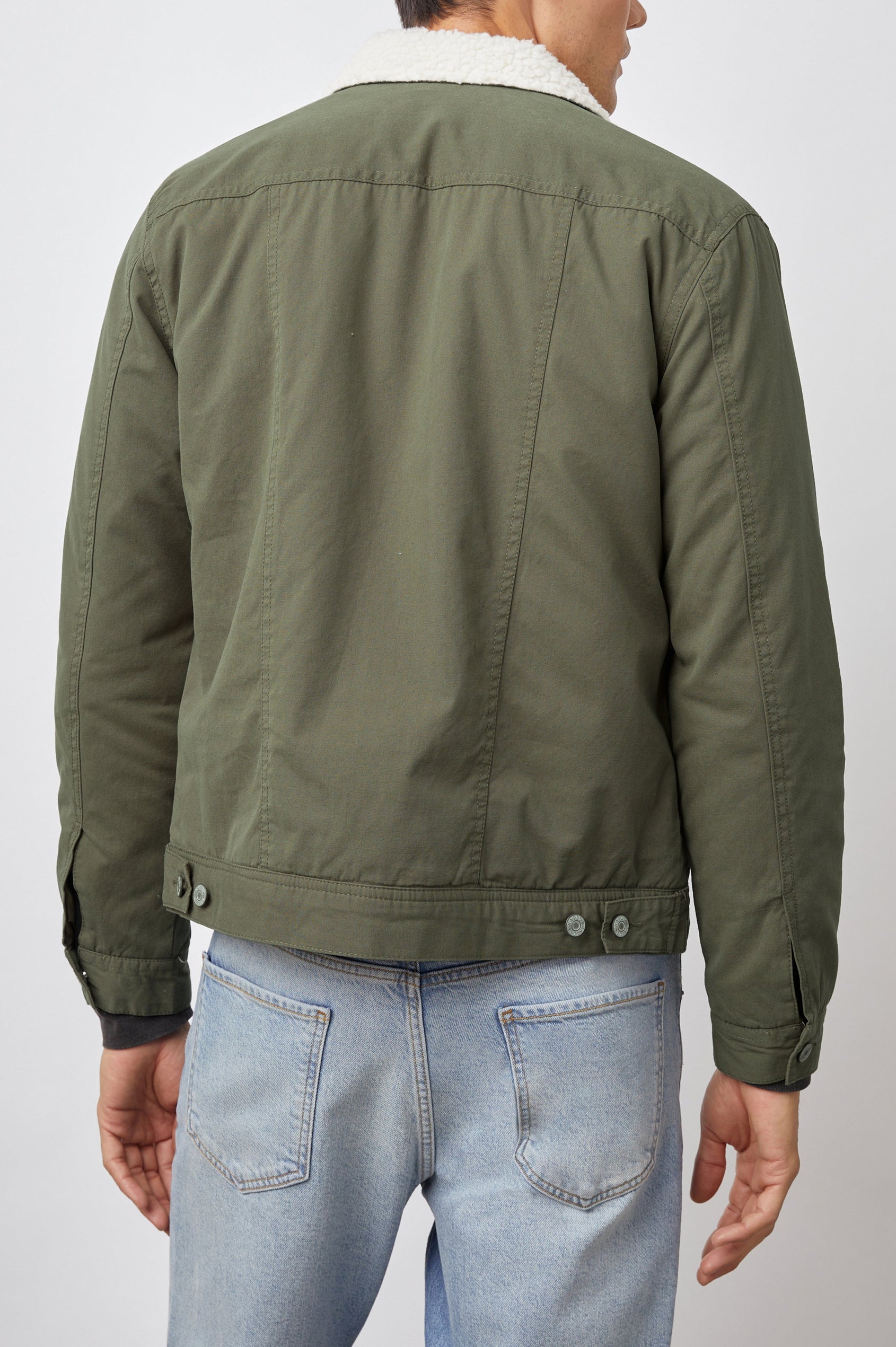 McKinley Jacket with Button Closure, Two Chest Button Flap Pockets, Two Front Pockets and a Cream Faux Sherpa Collar in Olive Colorway - Back View Featured on Model