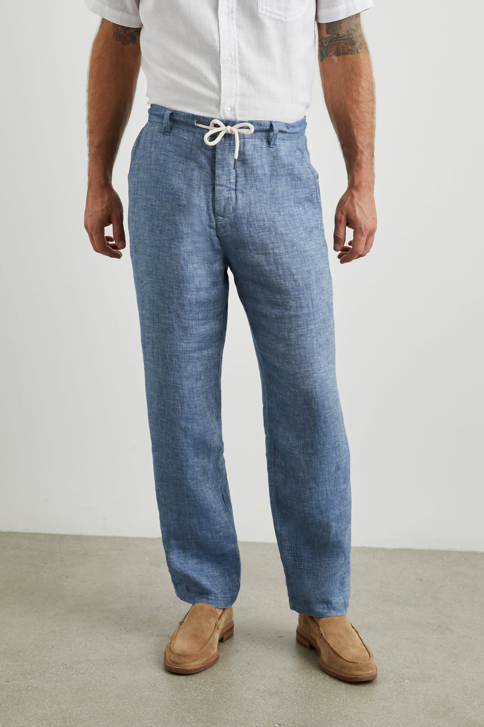 Mercer Pants with a Button and Drawcord Waist, Belt Loops, Two Front Pockets and Two Back Button Welt Pockets in Blue Mirage Colorway - Front View Featured on Model