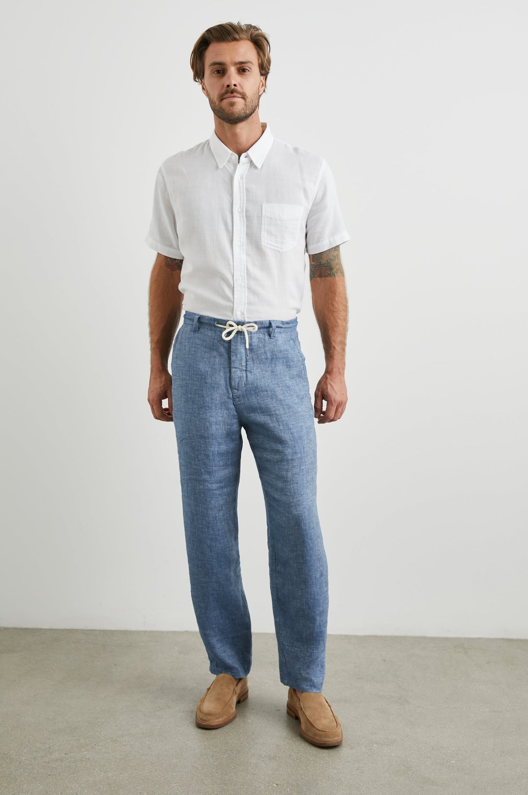 Mercer Pants with a Button and Drawcord Waist, Belt Loops, Two Front Pockets and Two Back Button Welt Pockets in Blue Mirage Colorway - Front Full Body View Featured on Model