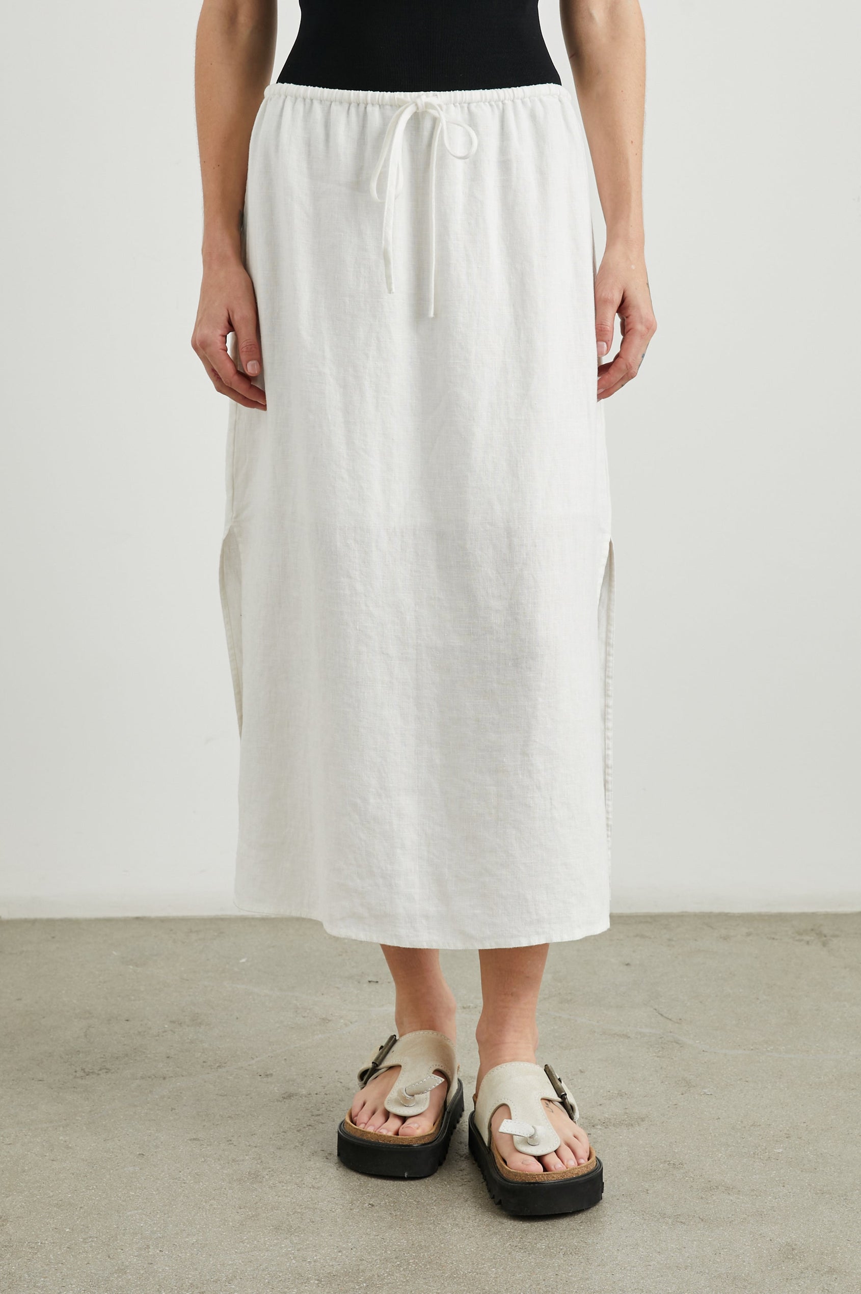 Monet Midi Skirt with Two Side Slits and a Drawstring Waist in White Colorway - Front View Featured on Model
