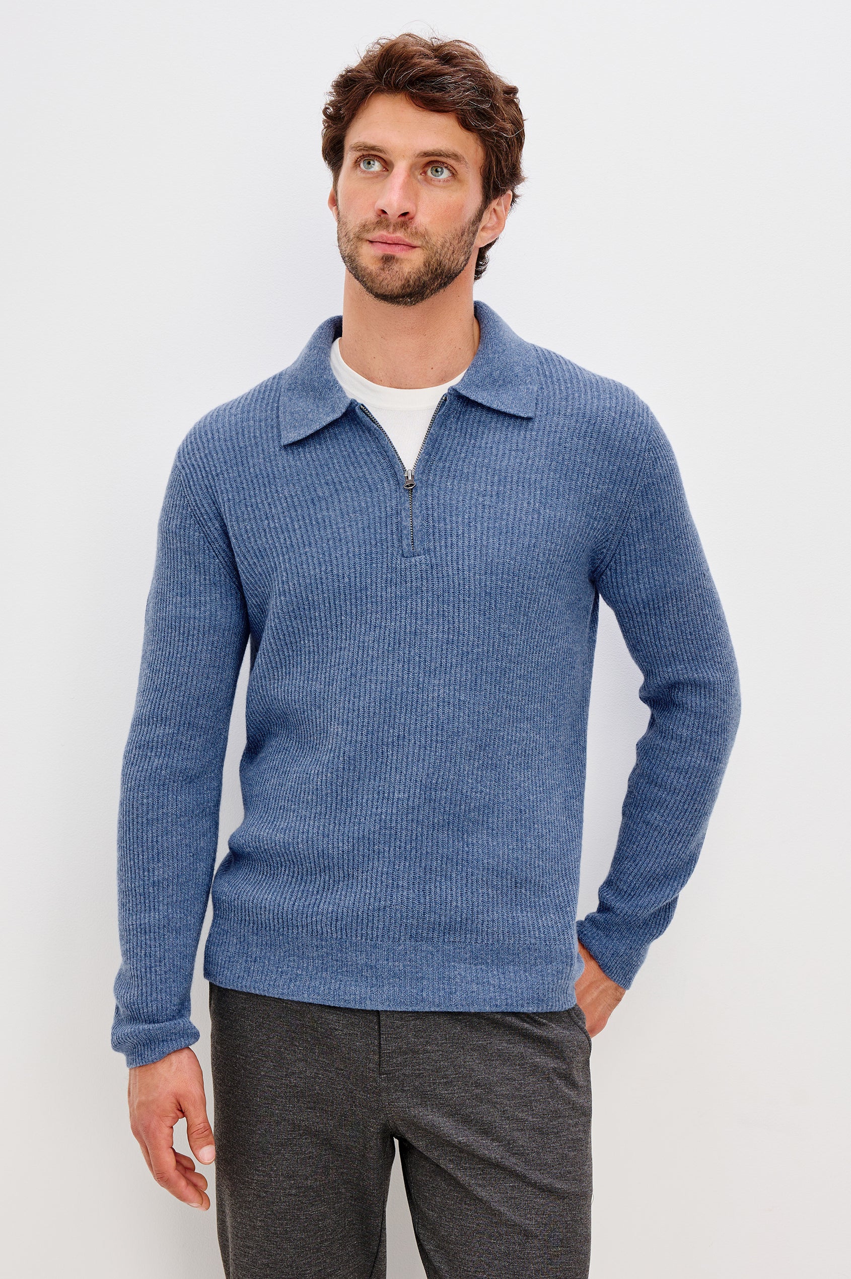 Monty is a collared quarter-zip long sleeved sweater in Cerulean Melange colorway. Front view featured on model.