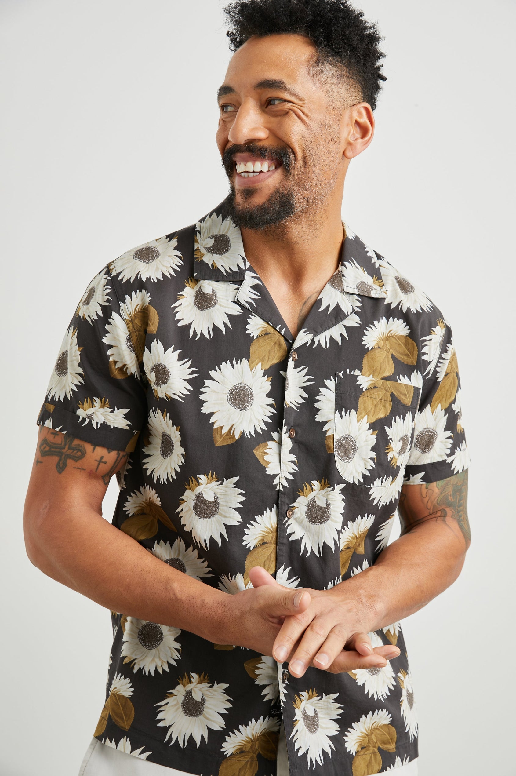 Moreno Short Sleeve Button Up with a Chest Patch Pocket in Sunflower Twirl Bark Colorway, White Sunflowers and Brown Leaves on Black - Front View Featured on Model