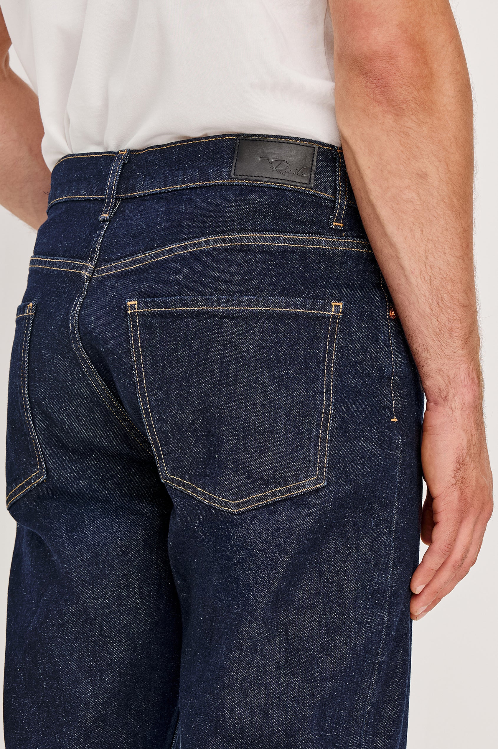 Nash is a straight leg 5-Pocket denim jean a zip fly and button closure as well as rivets in a Rinse Wash. Back detail view featured on model.