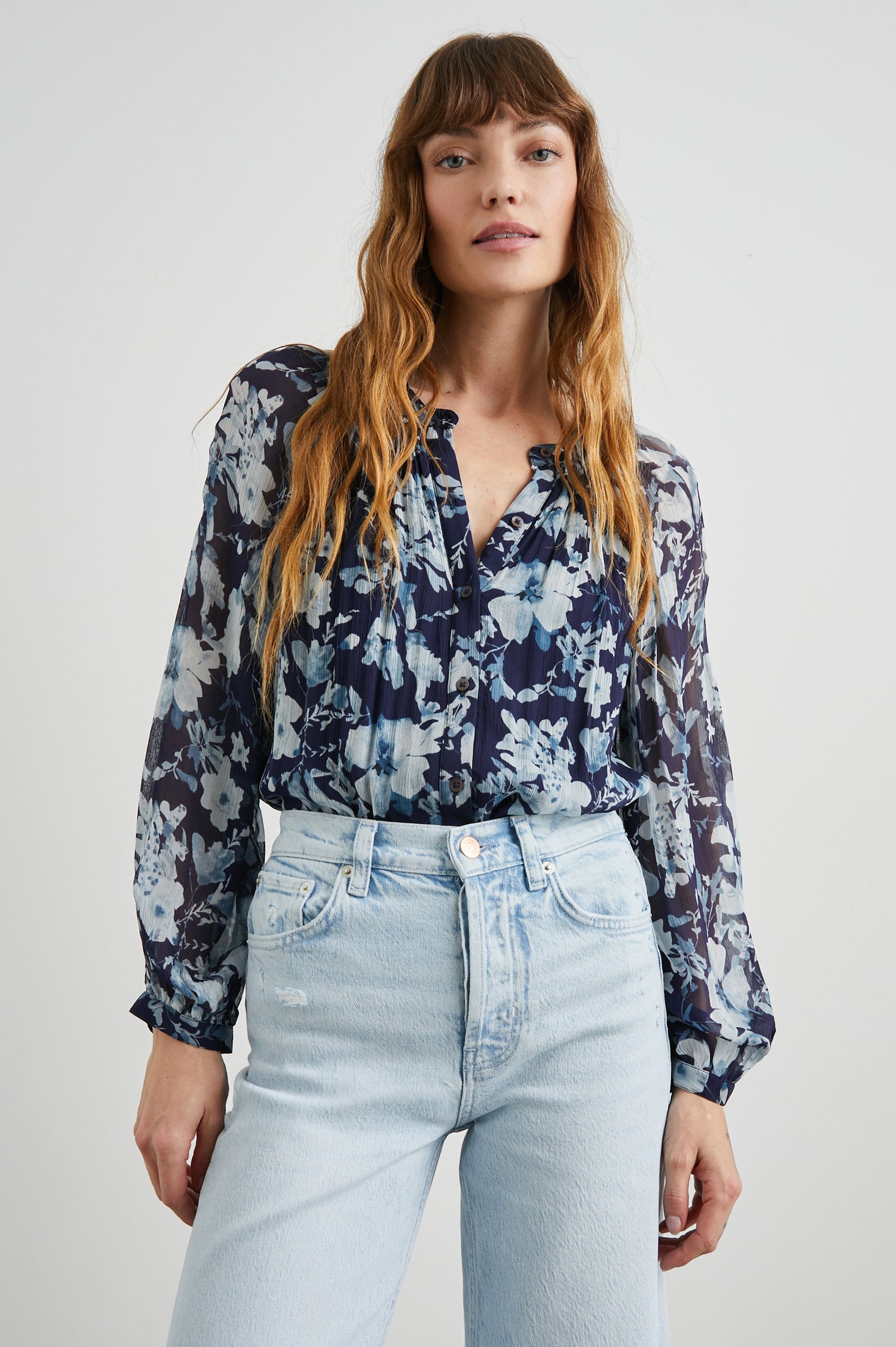 Nessie Long Sleeve Top with Front Button Closure and Ruching along the Neckline in Indigo Blossoms Colorway, Flowers in Blue on Indigo - Front Tucked View Featured on Model